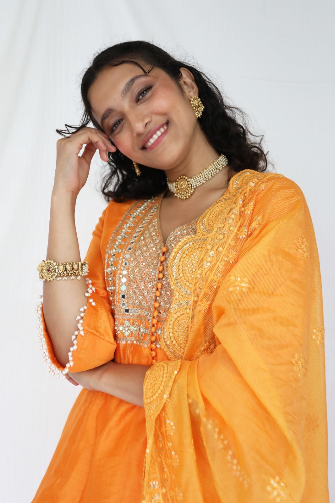 Orange chanderi kurta set with a hand embroidered yoke, intricate pearl detailing on the sleeves with an embellished scallop dupatta