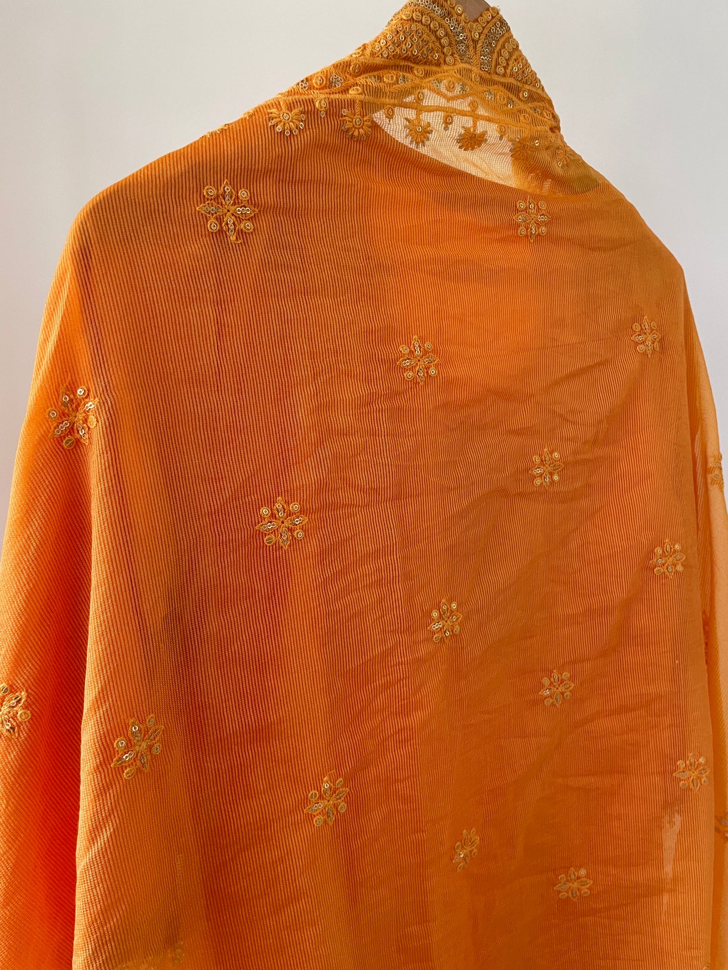 Orange chanderi kurta set with a hand embroidered yoke, intricate pearl detailing on the sleeves with an embellished scallop dupatta