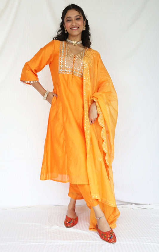 Orange chanderi kurta set with a hand embroidered yoke, intricate pearl detailing on the sleeves with an embellished scallop dupatta