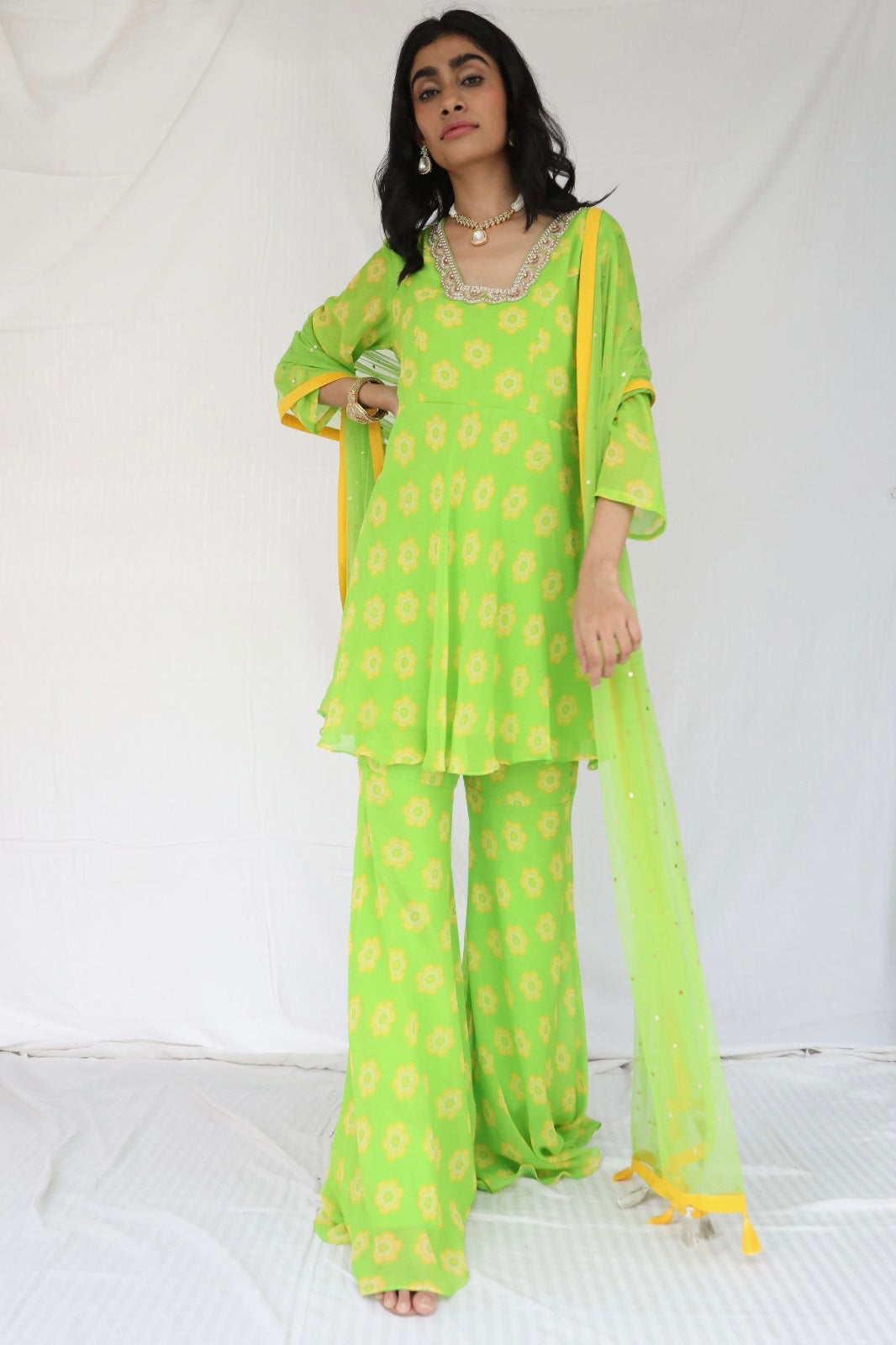 Green yellow floral printed sharara set with a hand embroidered neckline and dupatta