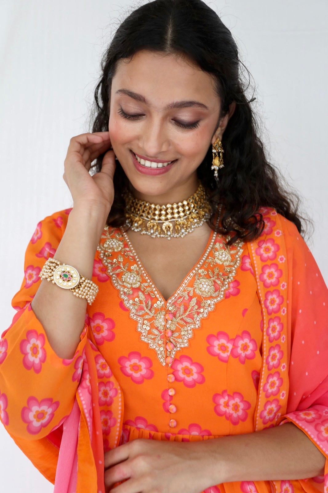 Orange pink sharara set with a hand embroidered neckline and ombré dupatta