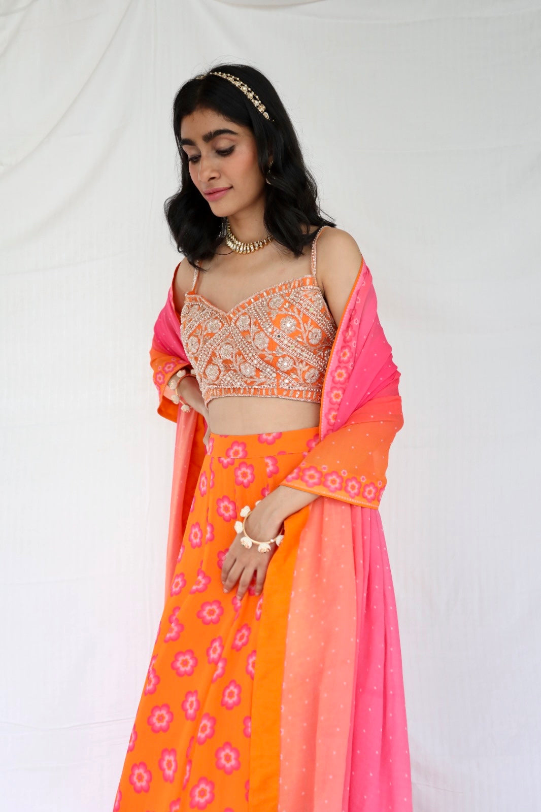 Orange lehenga with a hand embroidered blouse and a floral printed ombre dupatta