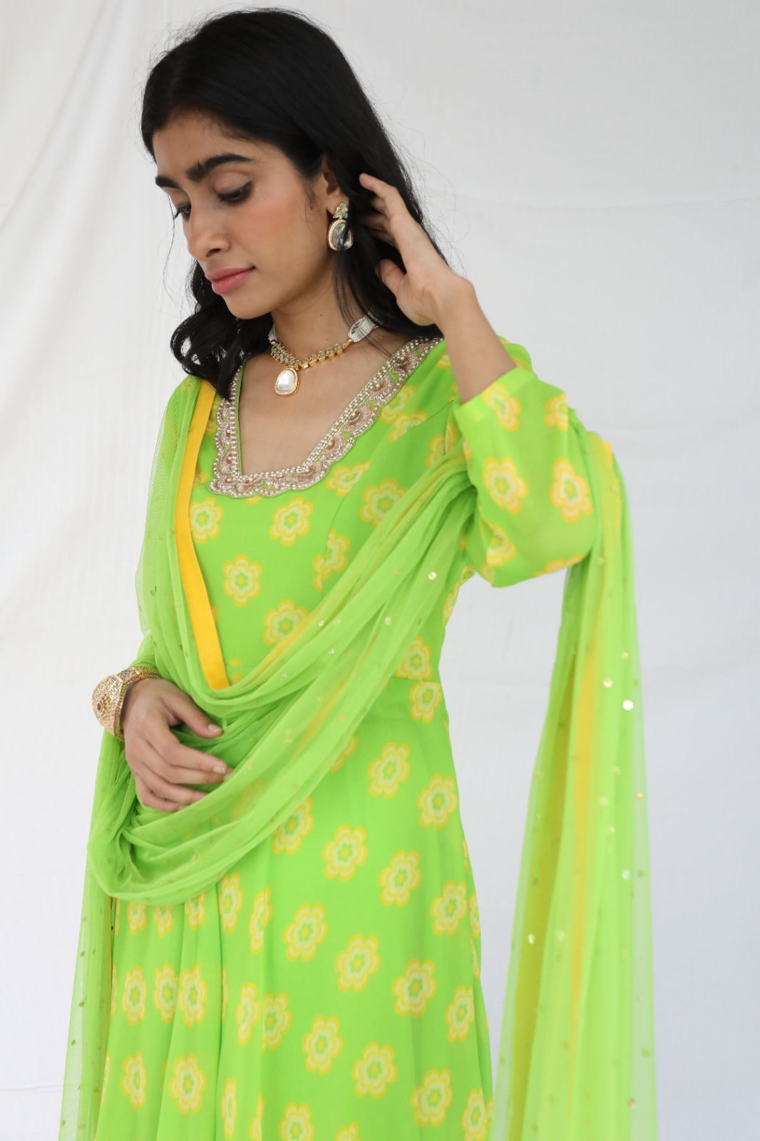 Green yellow floral printed sharara set with a hand embroidered neckline and dupatta