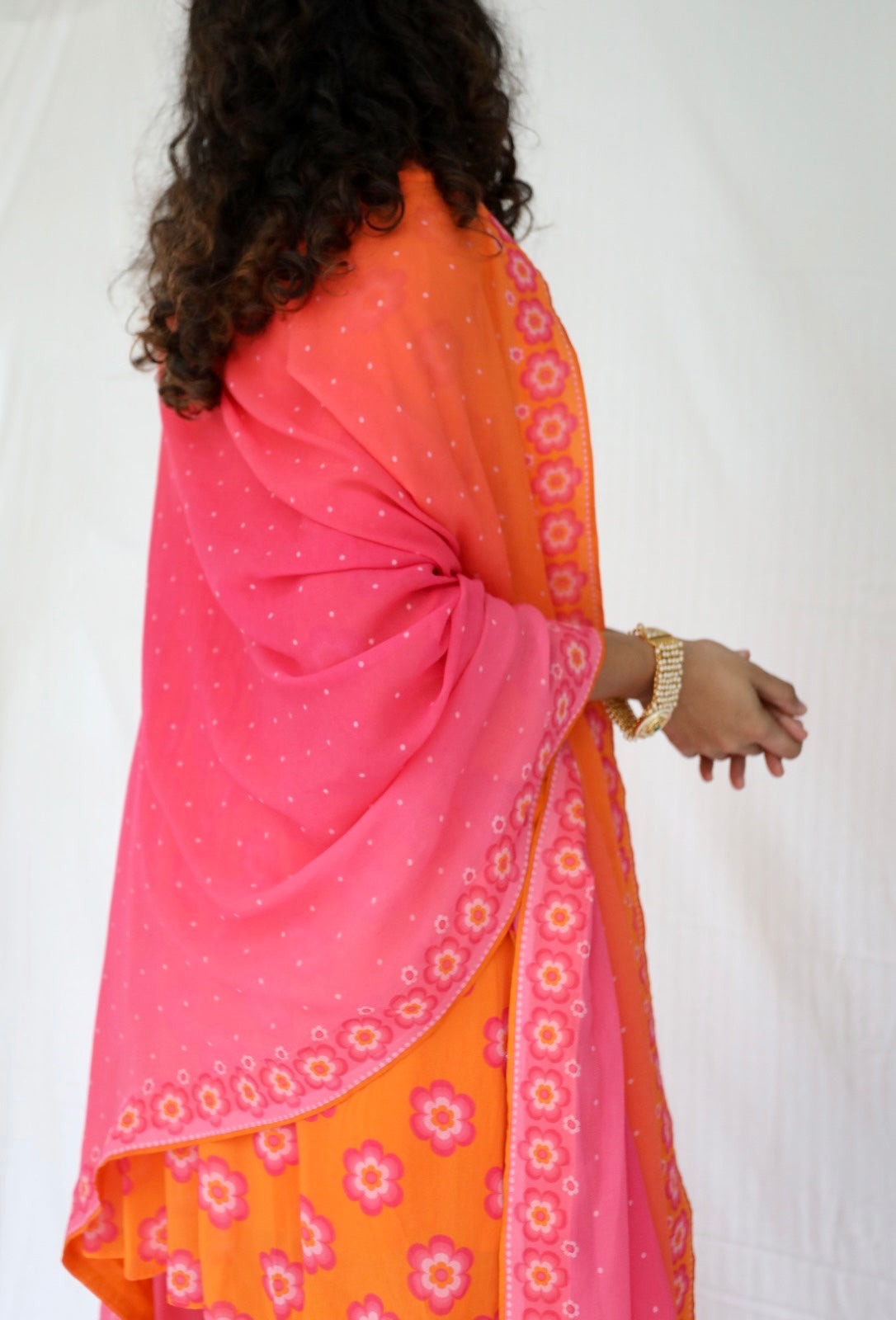 Orange pink sharara set with a hand embroidered neckline and ombré dupatta