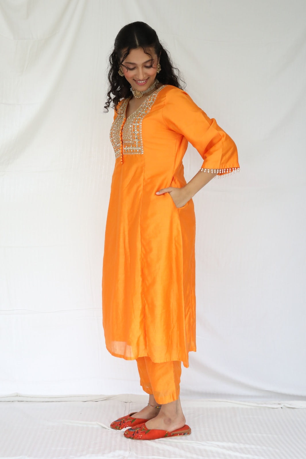 Orange chanderi kurta set with a hand embroidered yoke, intricate pearl detailing on the sleeves with an embellished scallop dupatta