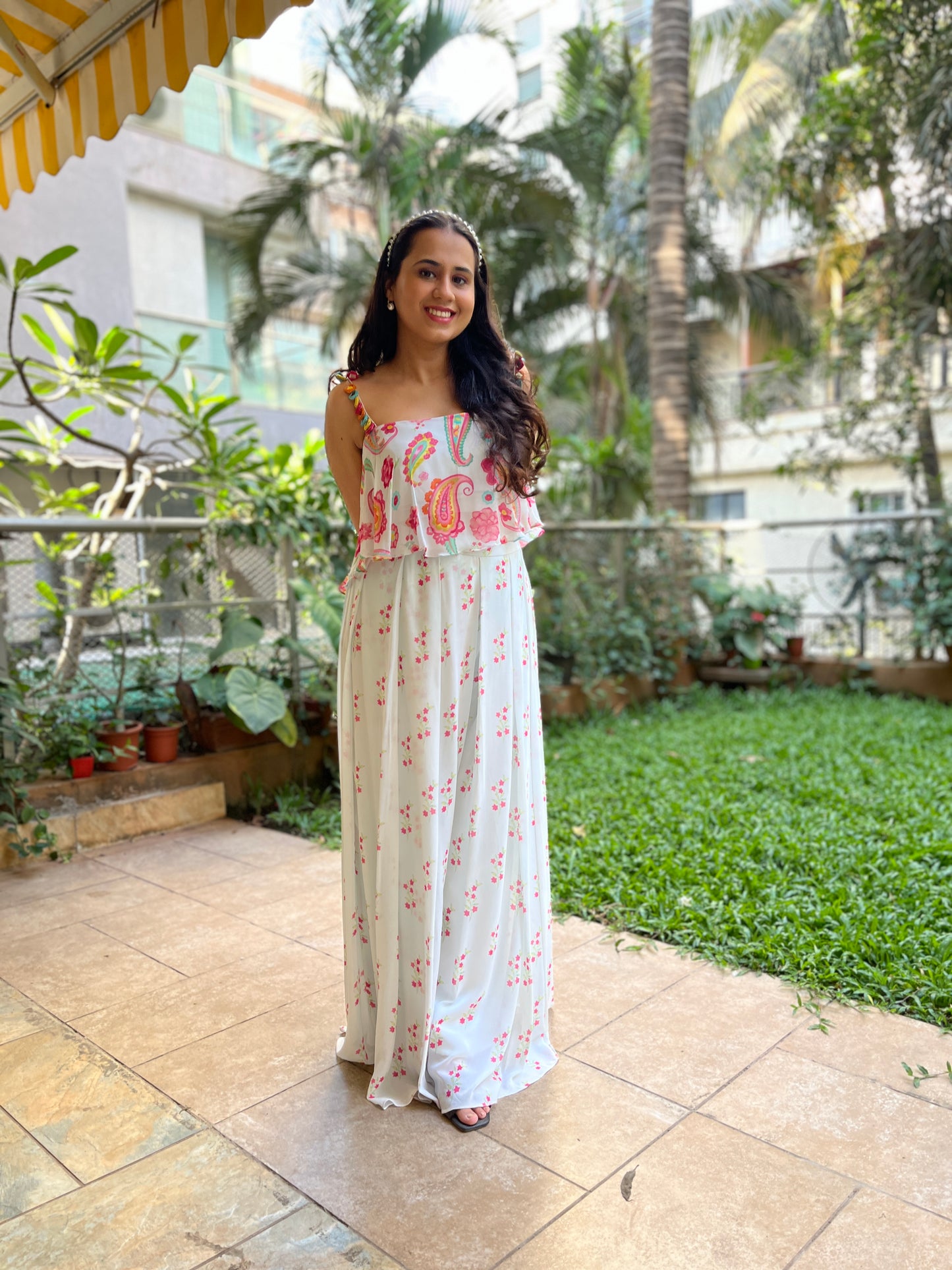 Ice blue paisley printed cami with colourful mirror work detailing and high waisted floral printed palazzo pants