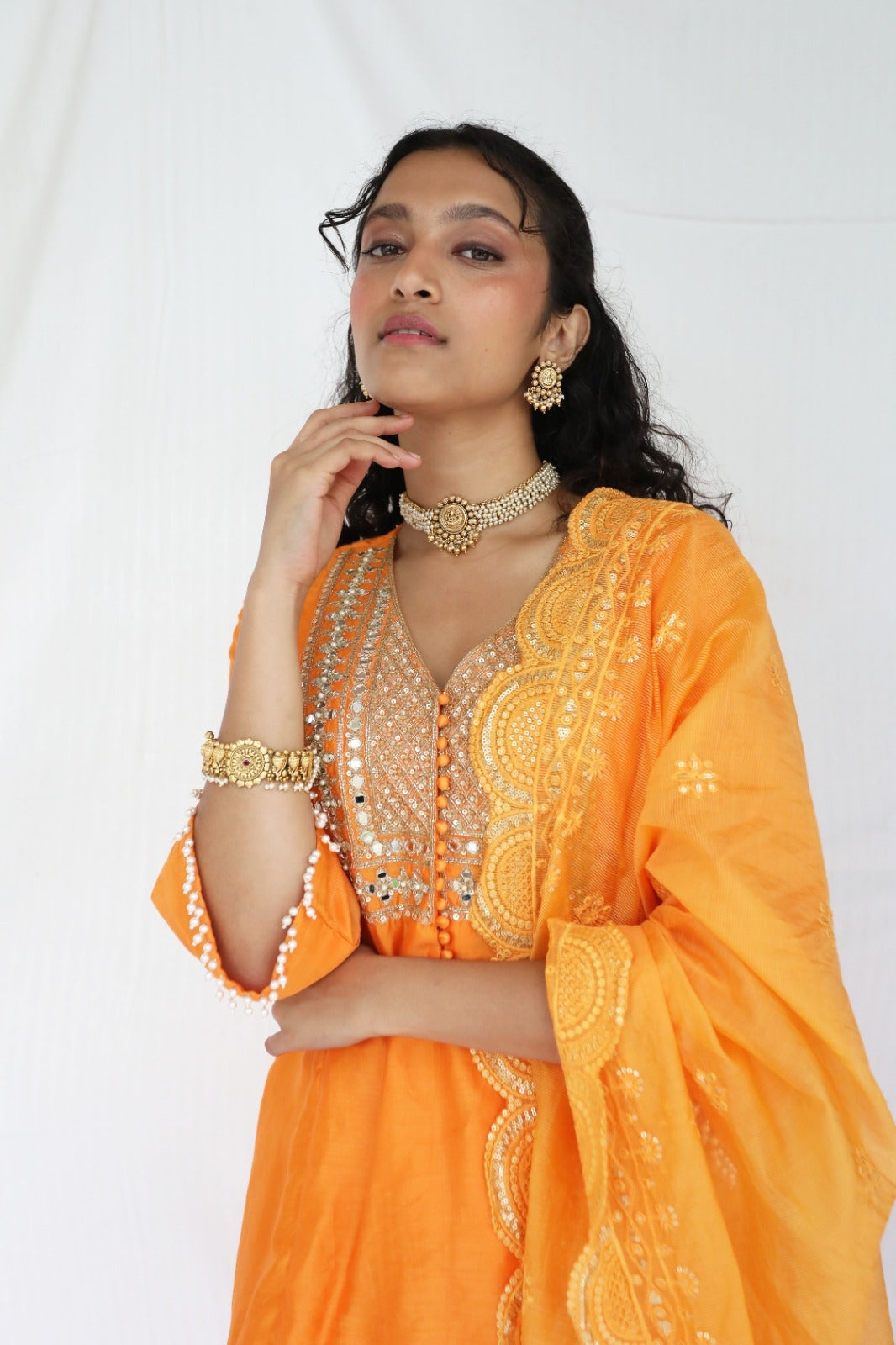 Orange chanderi kurta set with a hand embroidered yoke, intricate pearl detailing on the sleeves with an embellished scallop dupatta