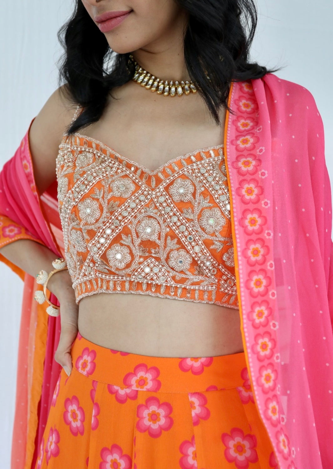 Orange lehenga with a hand embroidered blouse and a floral printed ombre dupatta