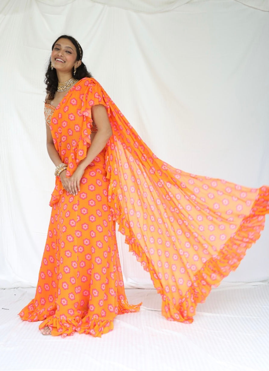 Floral printed orange pre stitched ruffle sari with a hand embroidered blouse