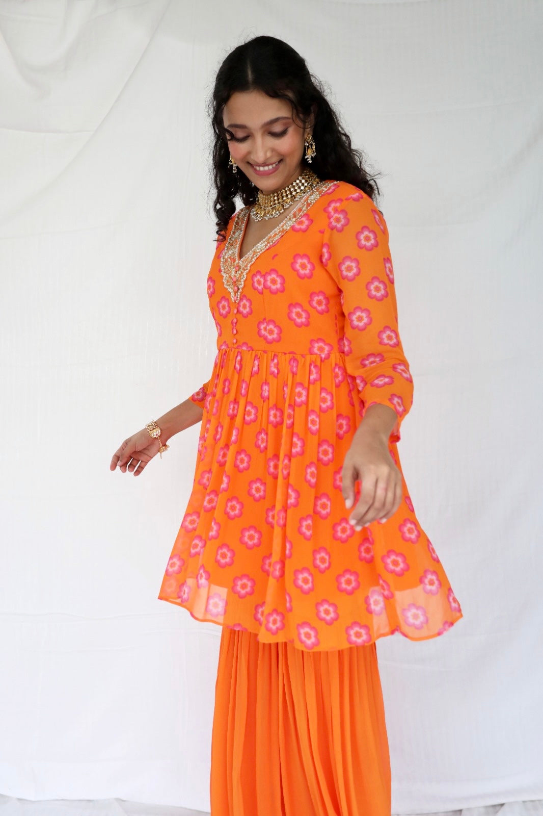 Orange pink sharara set with a hand embroidered neckline and ombré dupatta