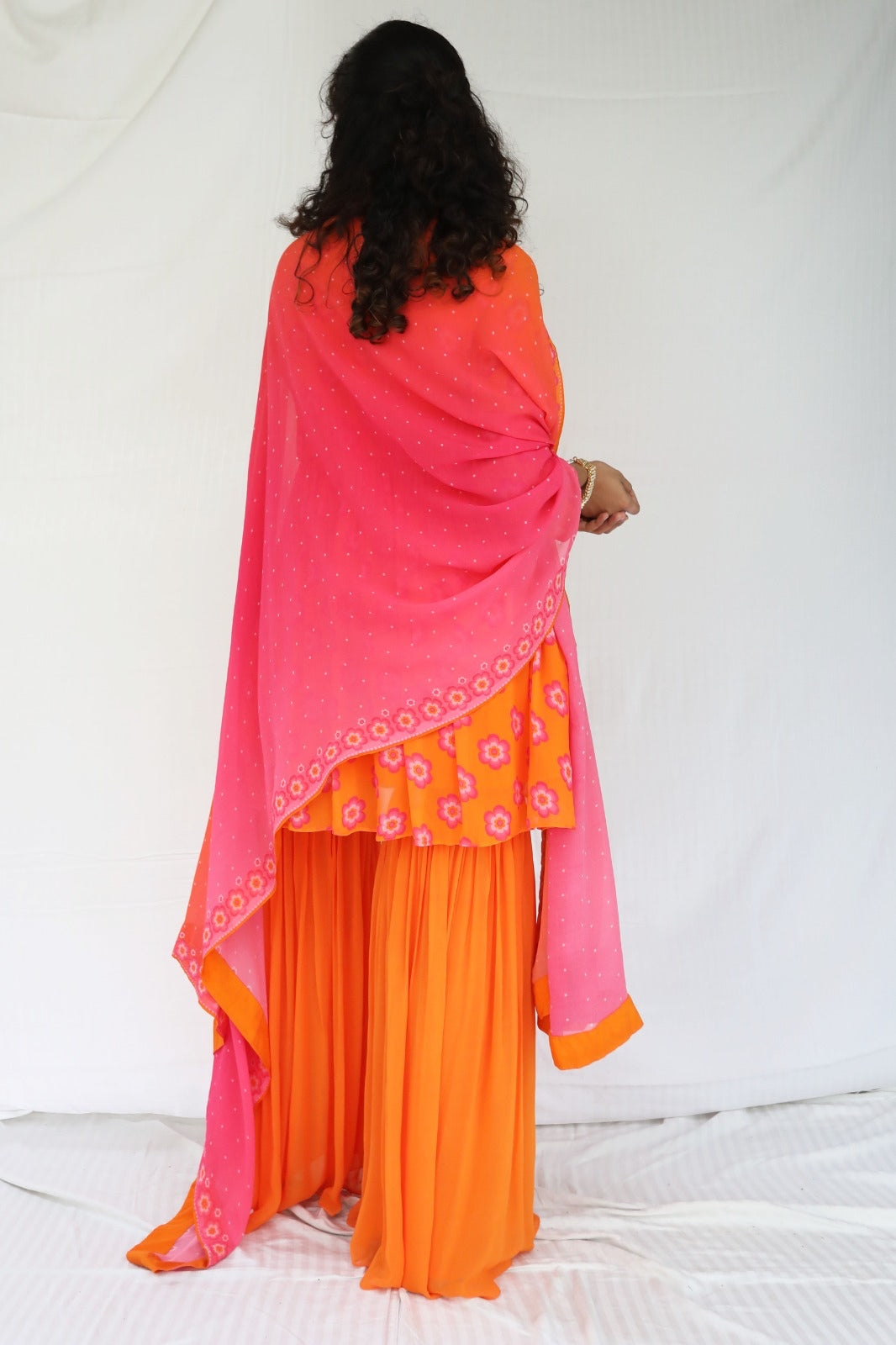 Orange pink sharara set with a hand embroidered neckline and ombré dupatta