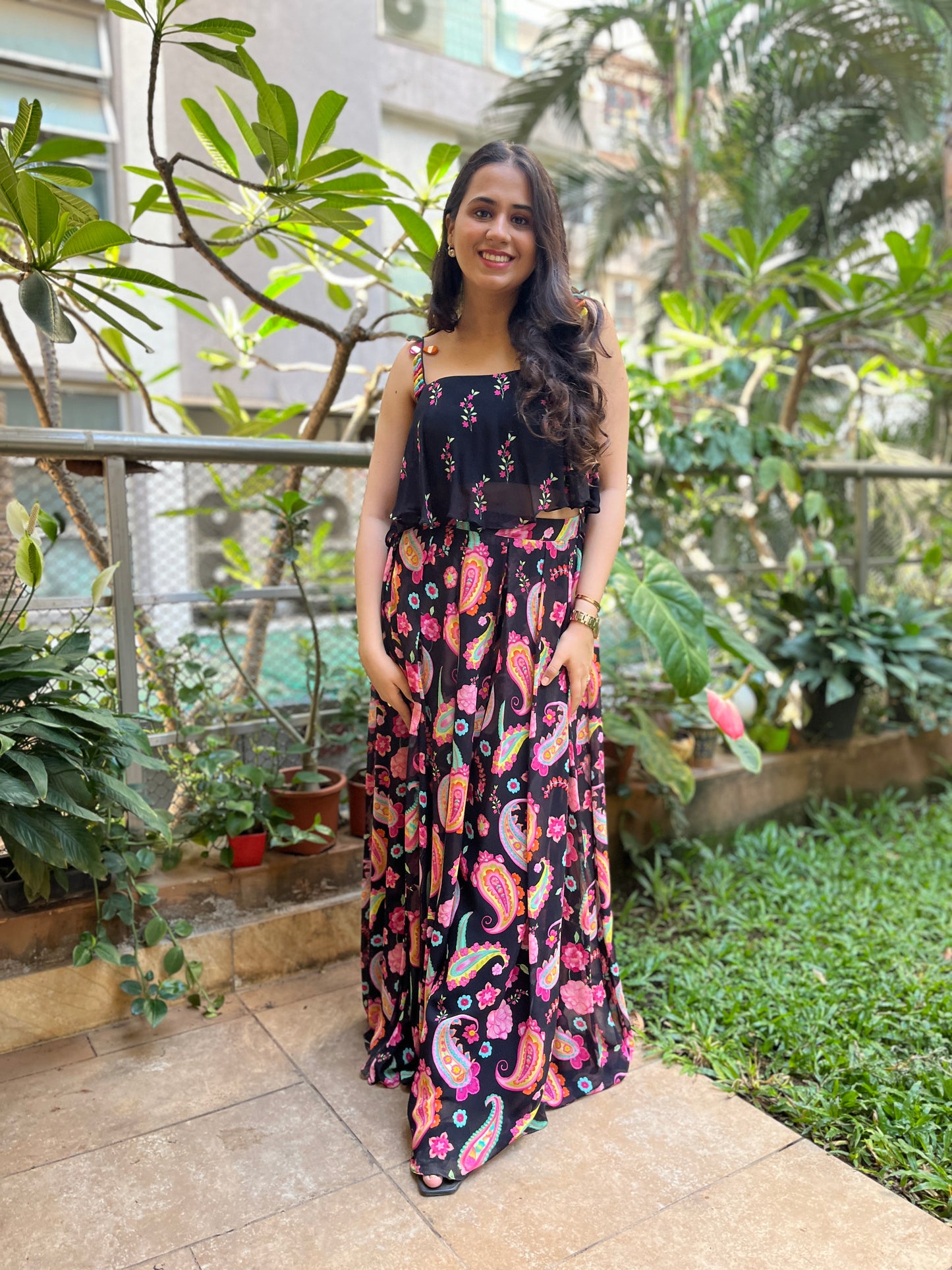 Black floral printed cami with colorful mirror work detailing with paisley printed high waisted palazzo pants