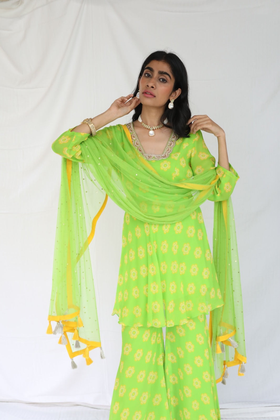 Green yellow floral printed sharara set with a hand embroidered neckline and dupatta