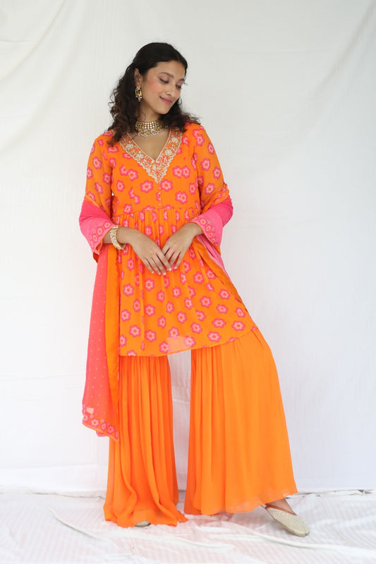 Orange pink sharara set with a hand embroidered neckline and ombré dupatta