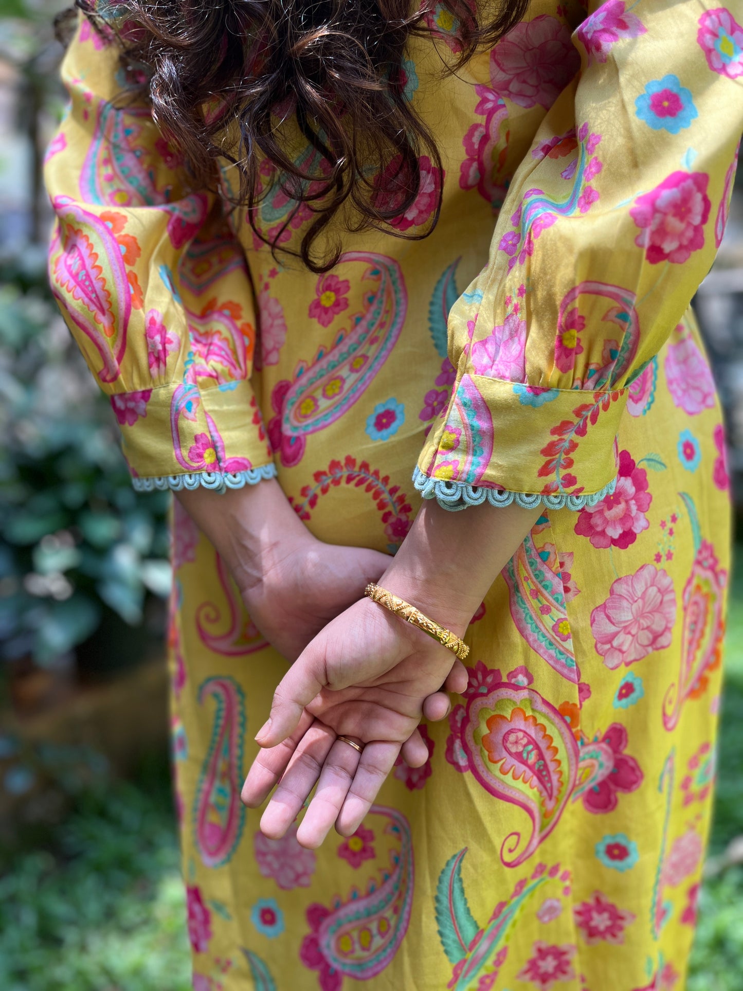 Yellow paisley printed kurta with intricate lace detailing, pyjama pants and an organza dupatta