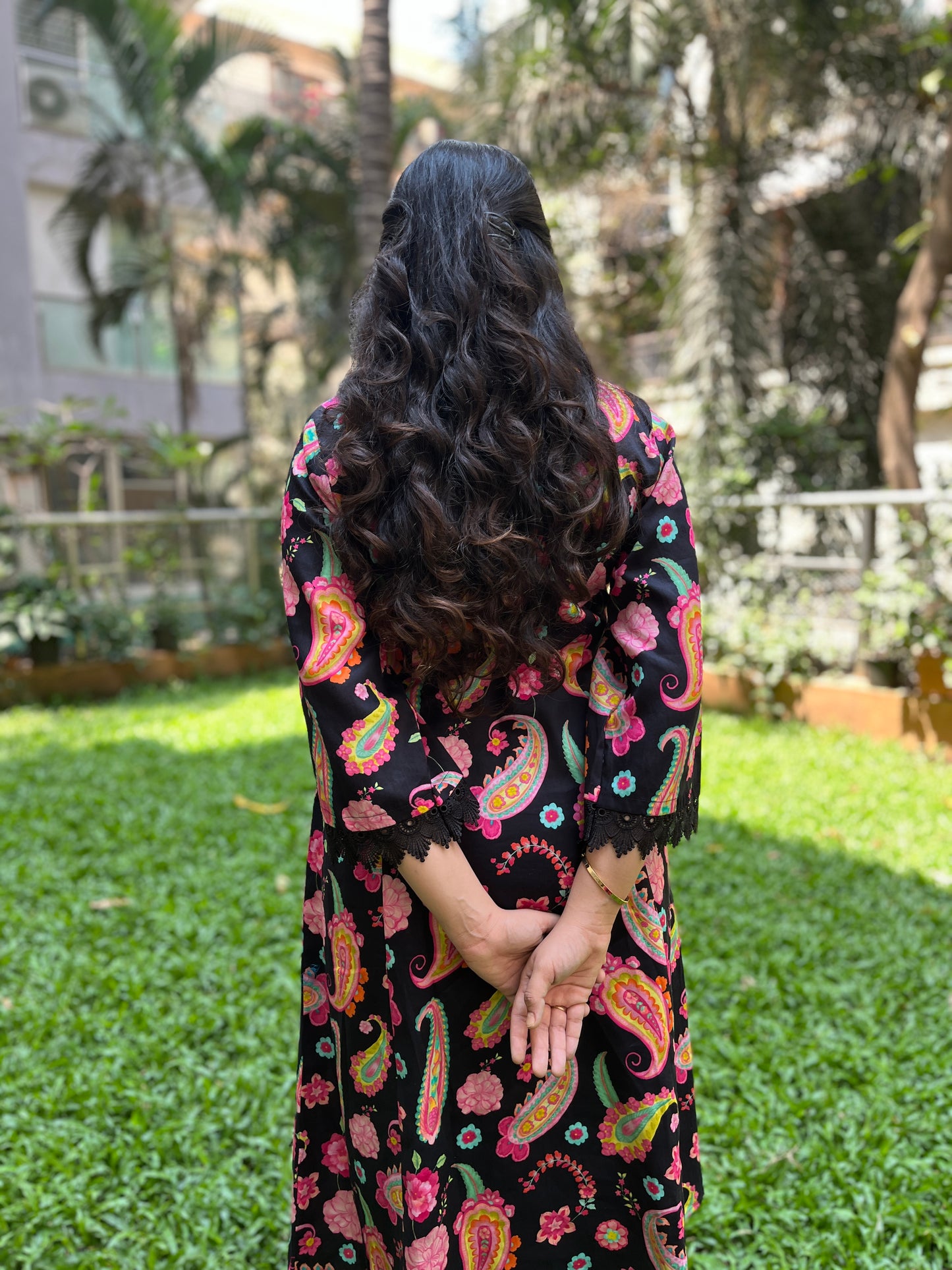 Black paisley printed kurta with a floral printed organza dupatta and pyjama pants