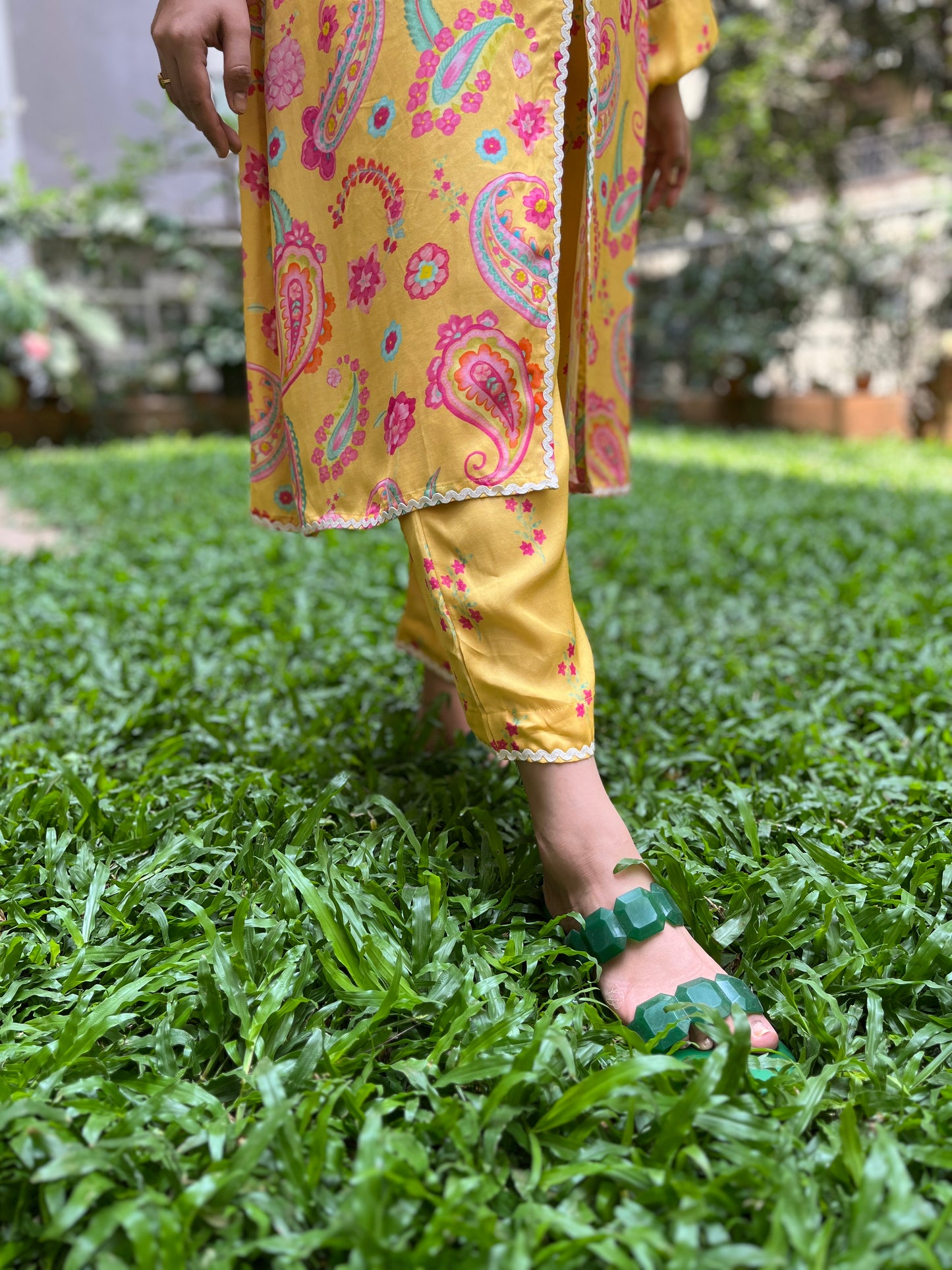 Yellow paisley printed kurta with intricate lace detailing and floral printed pyjama pants