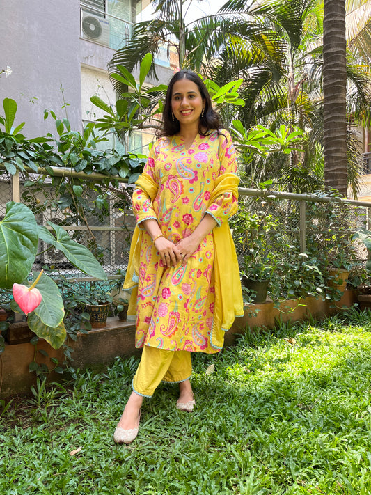 Yellow paisley printed kurta with intricate lace detailing, pyjama pants and an organza dupatta