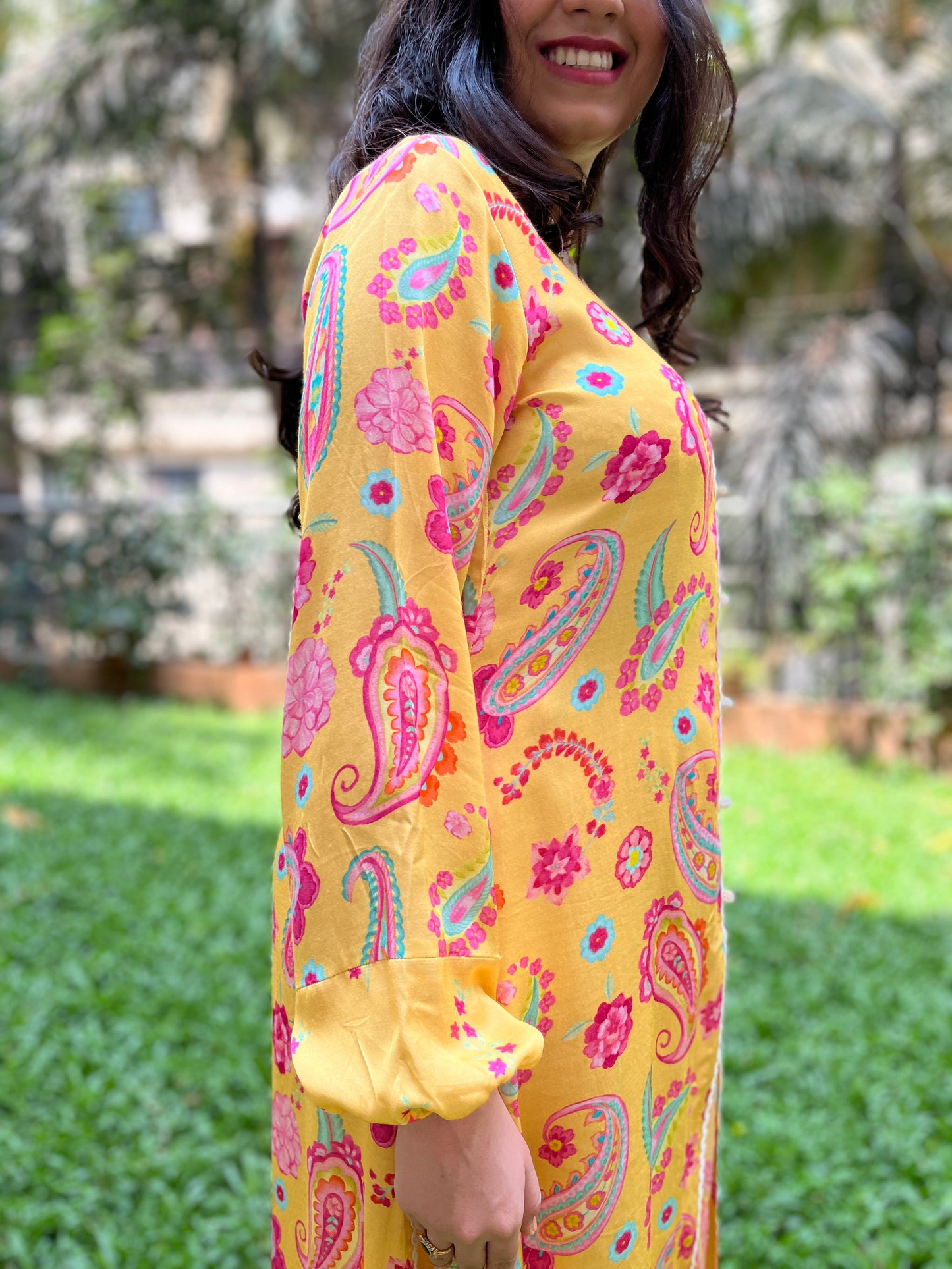 Yellow paisley printed kurta with intricate lace detailing and floral printed pyjama pants