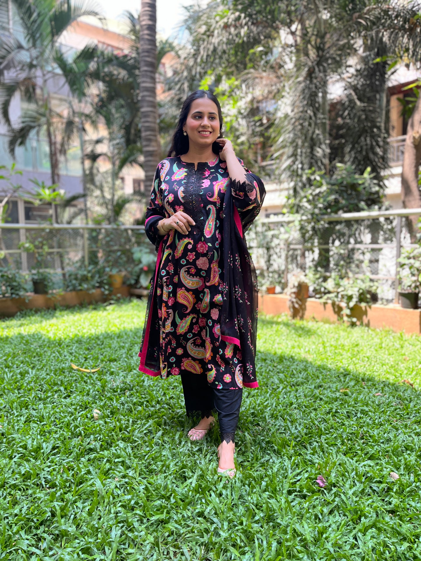 Black paisley printed kurta with a floral printed organza dupatta and pyjama pants