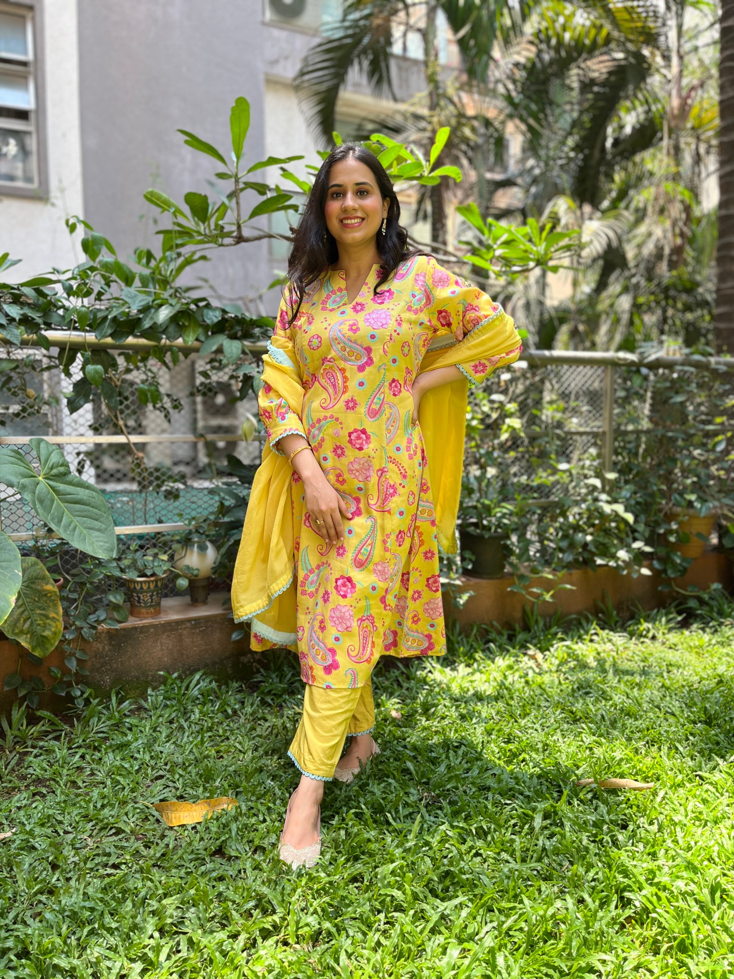 Yellow paisley printed kurta with intricate lace detailing, pyjama pants and an organza dupatta