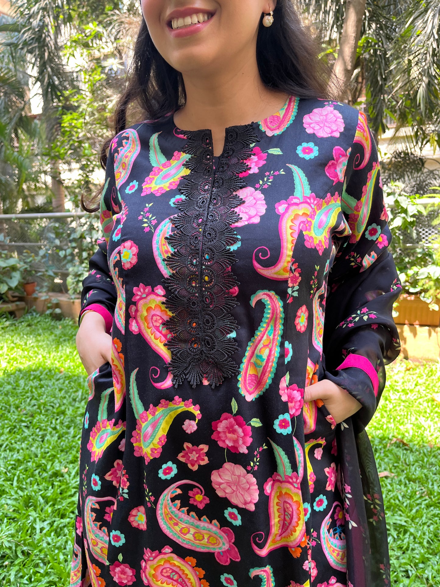 Black paisley printed kurta with a floral printed organza dupatta and pyjama pants