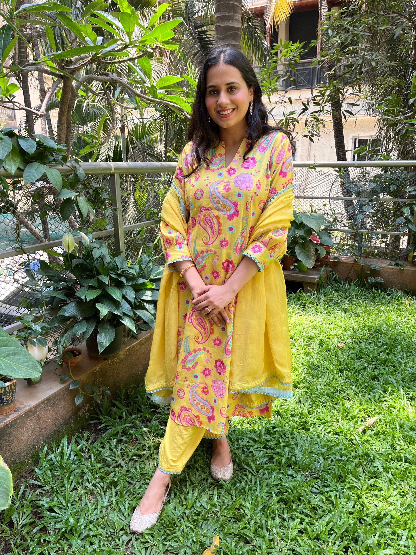 Yellow paisley printed kurta with intricate lace detailing, pyjama pants and an organza dupatta