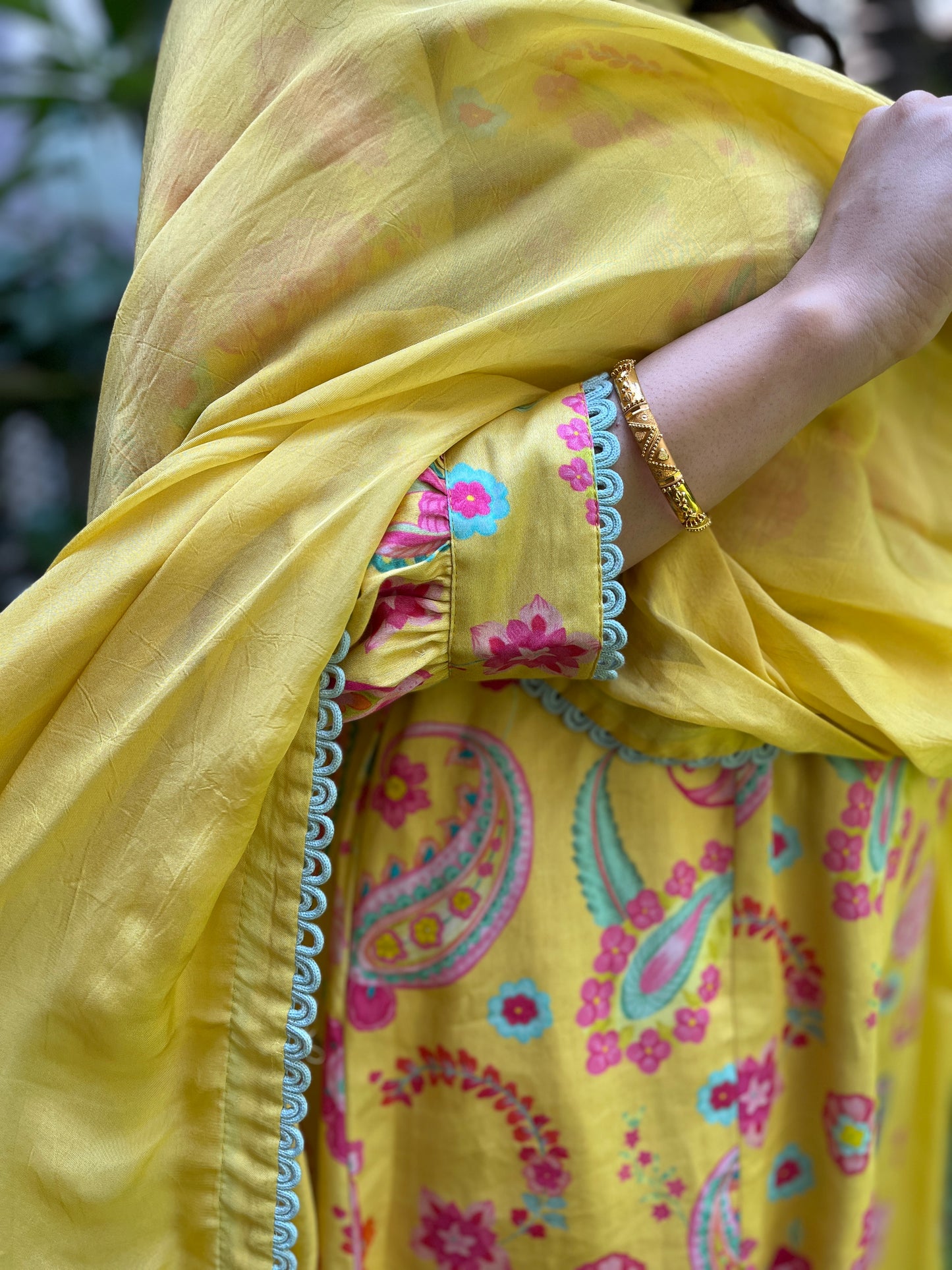 Yellow paisley printed kurta with intricate lace detailing, pyjama pants and an organza dupatta