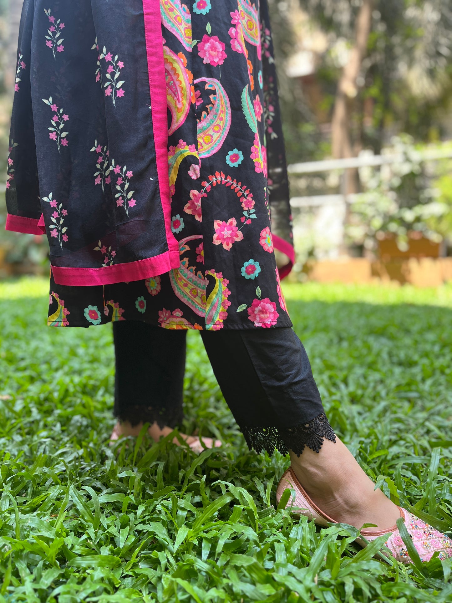 Black paisley printed kurta with a floral printed organza dupatta and pyjama pants