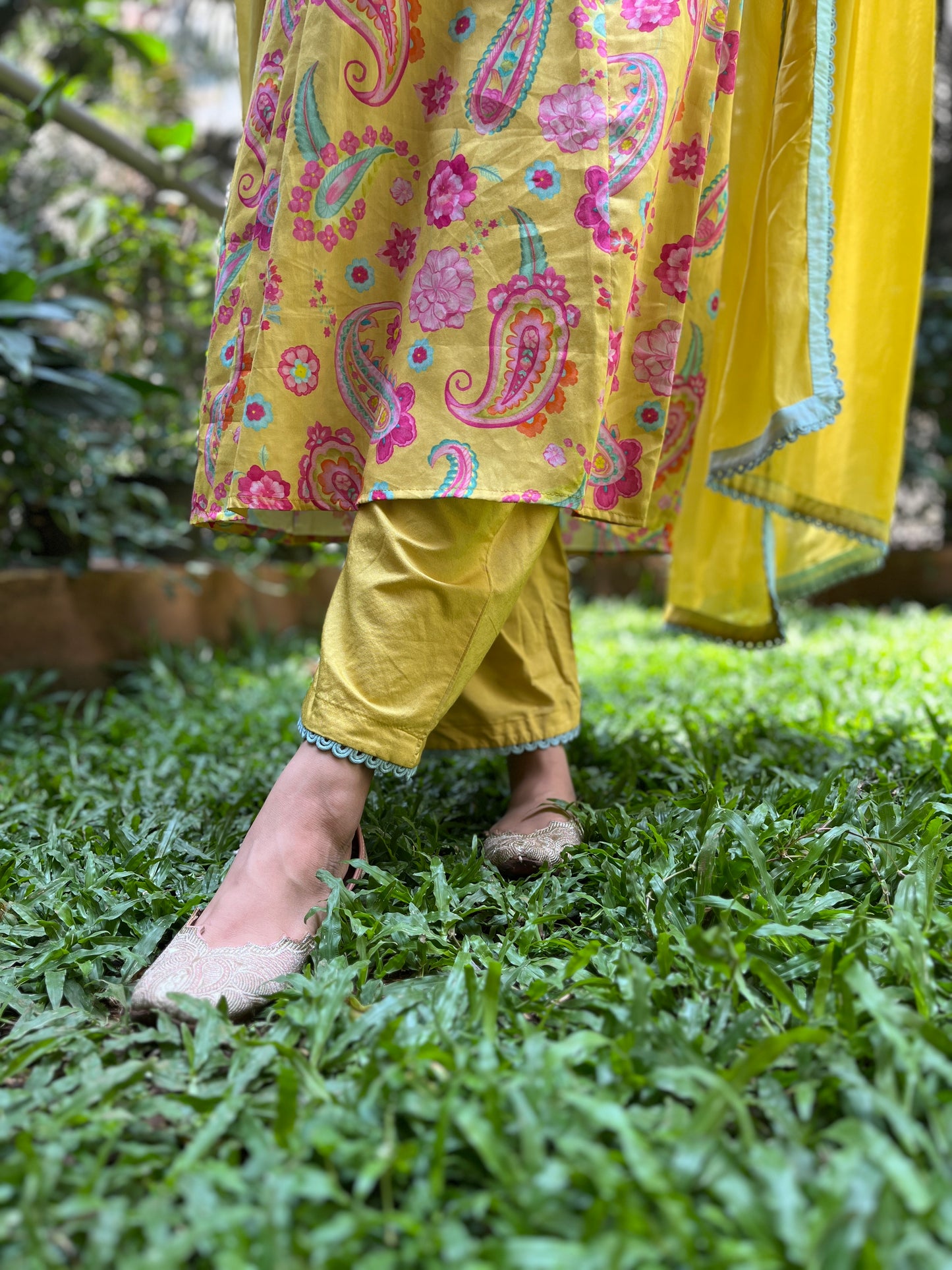 Yellow paisley printed kurta with intricate lace detailing, pyjama pants and an organza dupatta