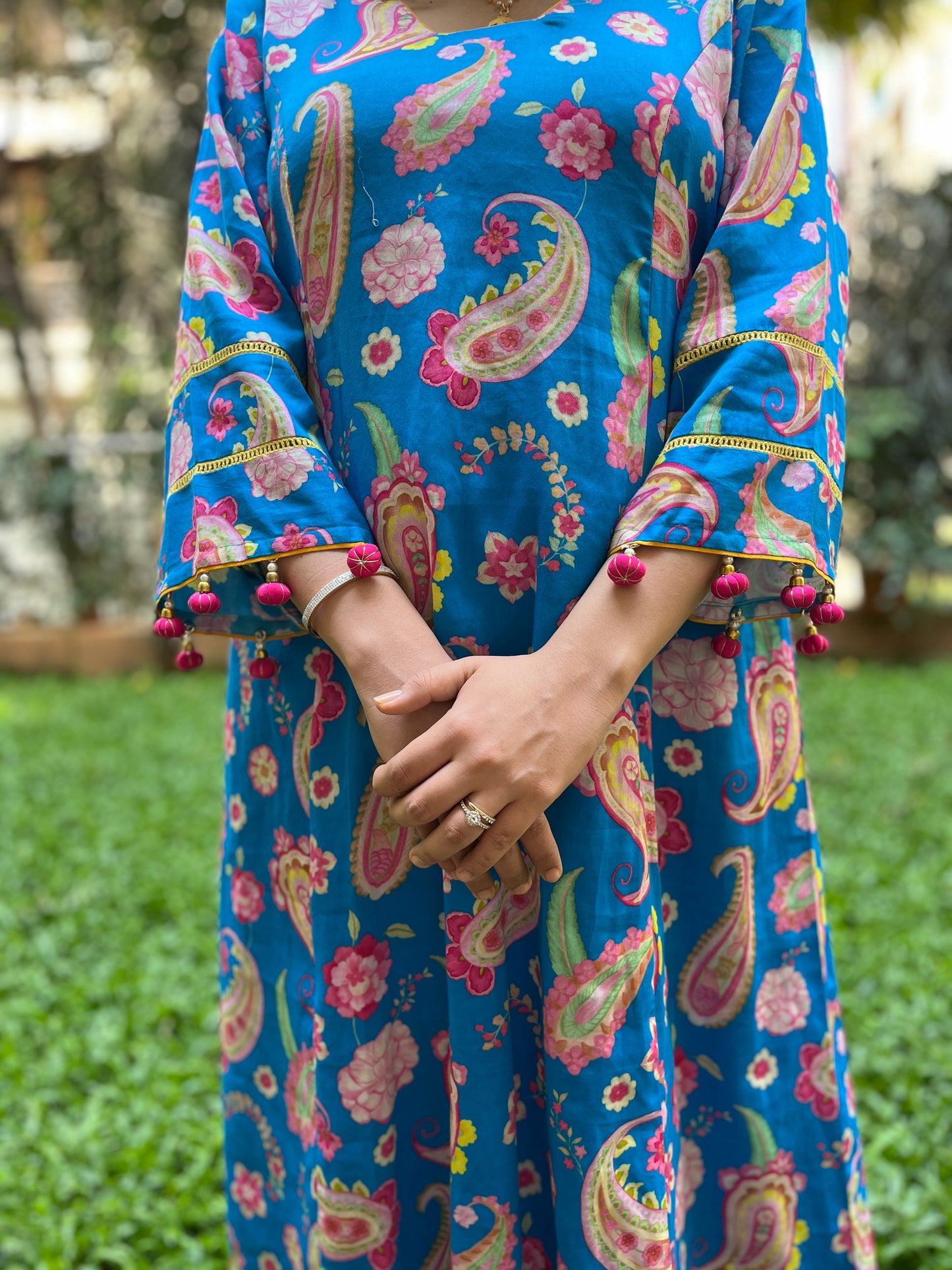 Peacock blue paisley printed kurta with tassel detailing, floral printed organza dupatta and pyjama pants