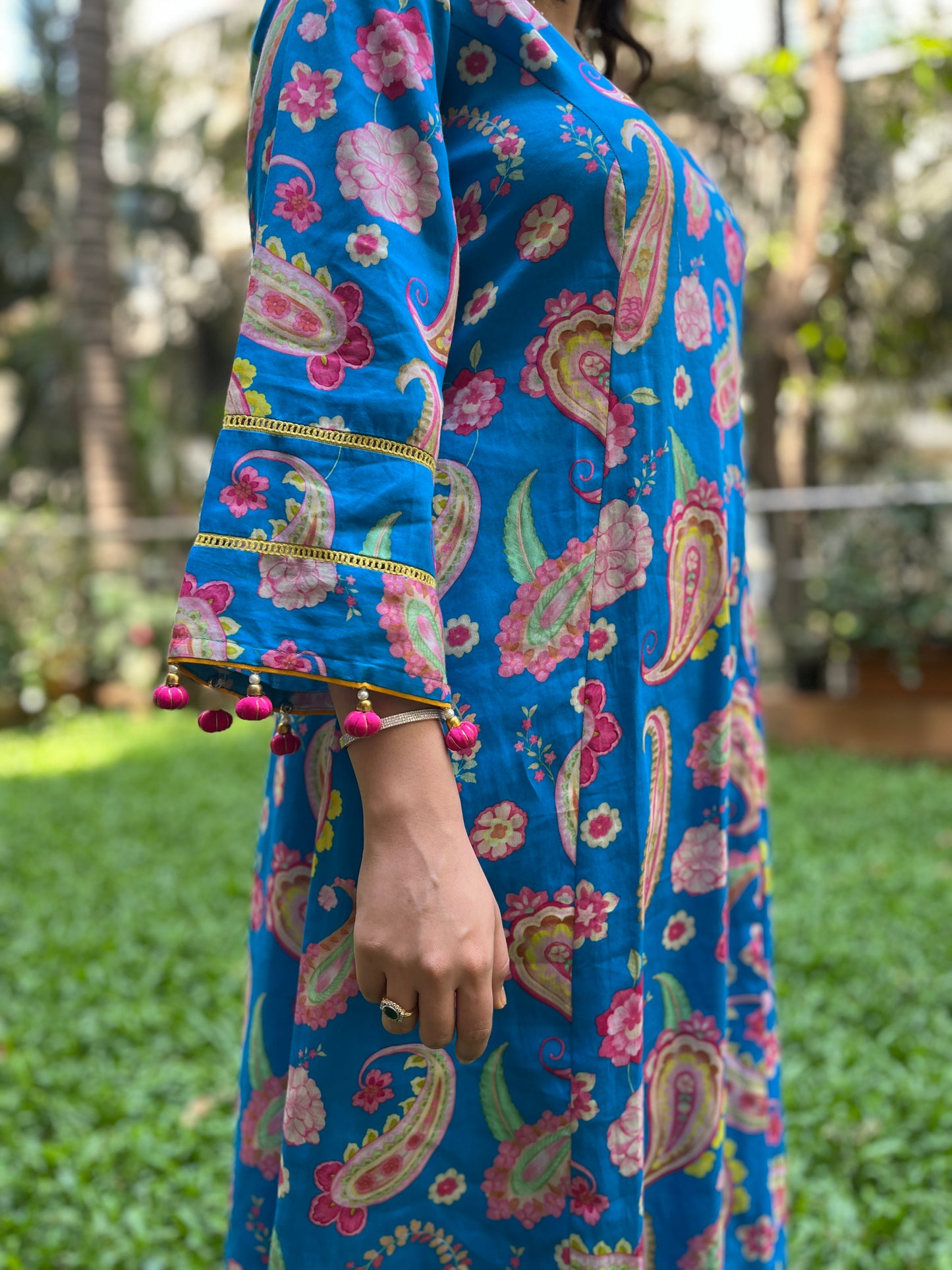 Peacock blue paisley printed kurta with tassel detailing, floral printed organza dupatta and pyjama pants