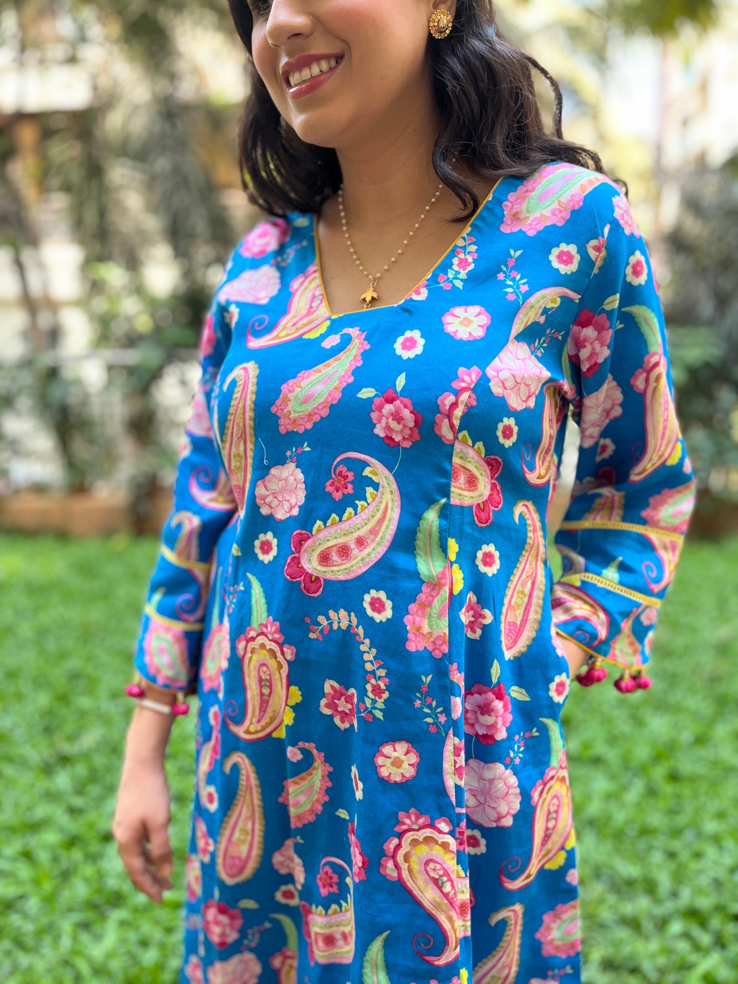 Peacock blue paisley printed kurta with tassel detailing, floral printed organza dupatta and pyjama pants