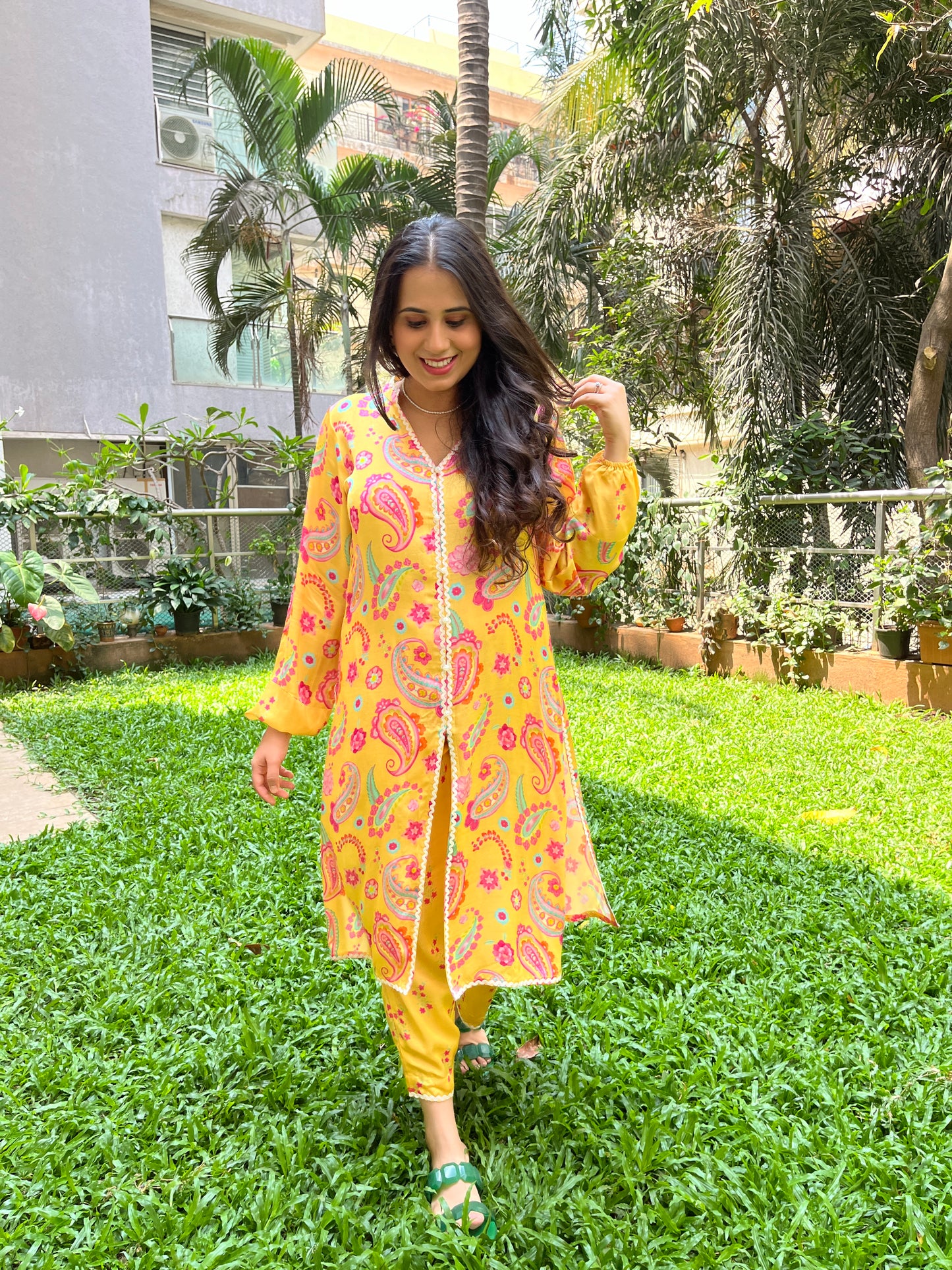 Yellow paisley printed kurta with intricate lace detailing and floral printed pyjama pants