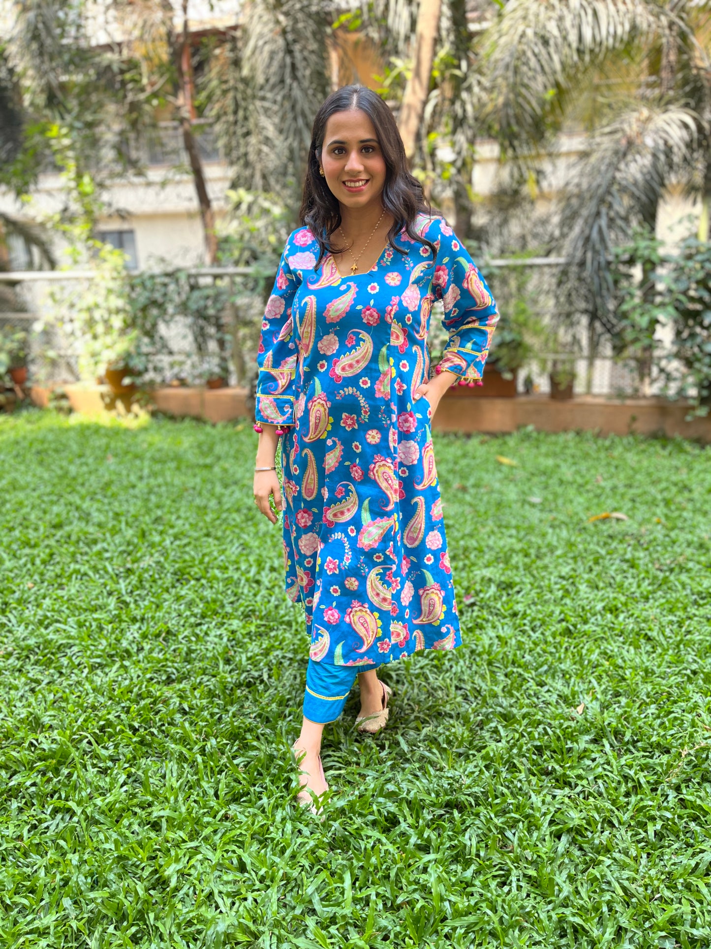 Peacock blue paisley printed kurta with tassel detailing, floral printed organza dupatta and pyjama pants