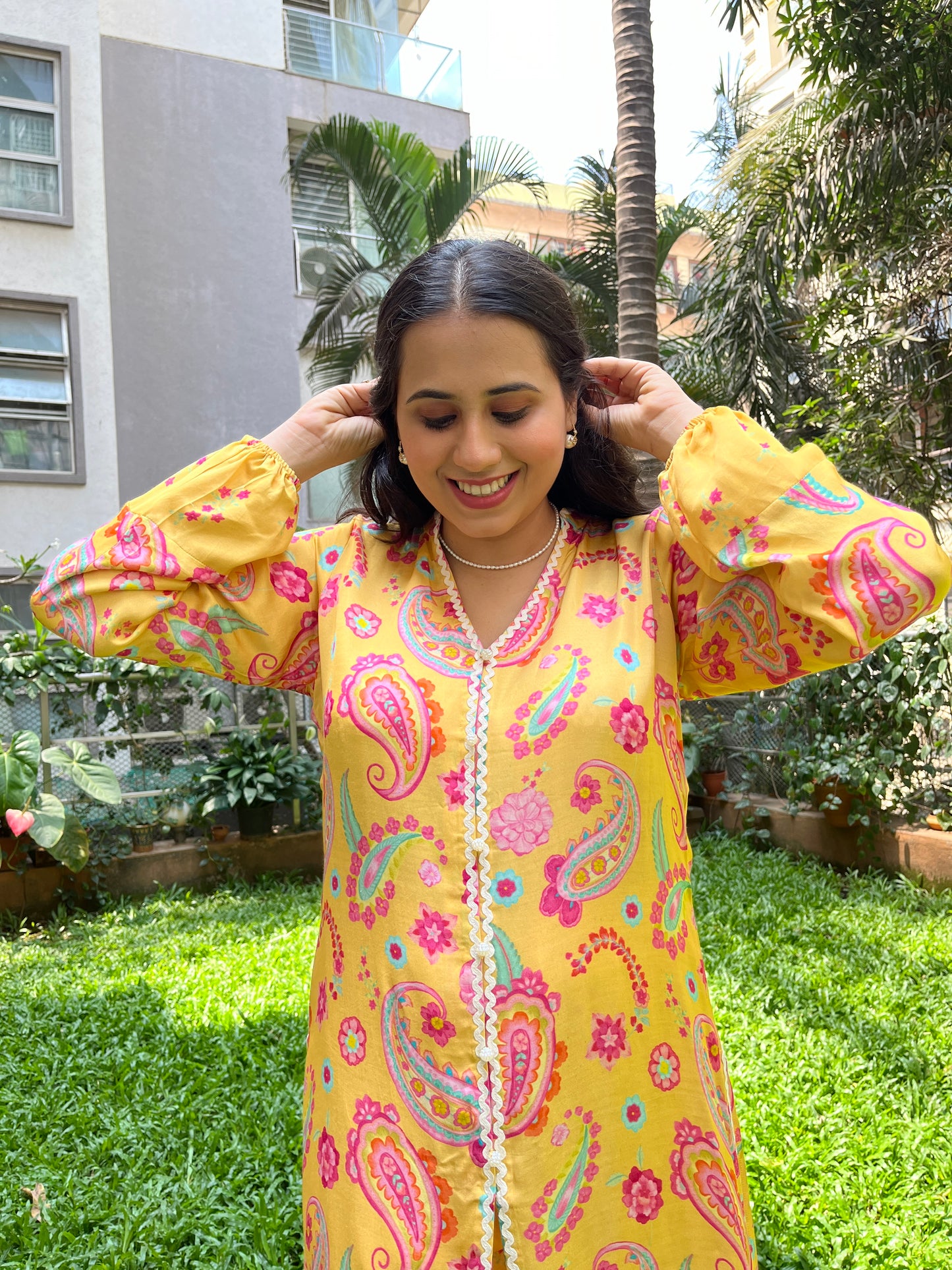 Yellow paisley printed kurta with intricate lace detailing and floral printed pyjama pants