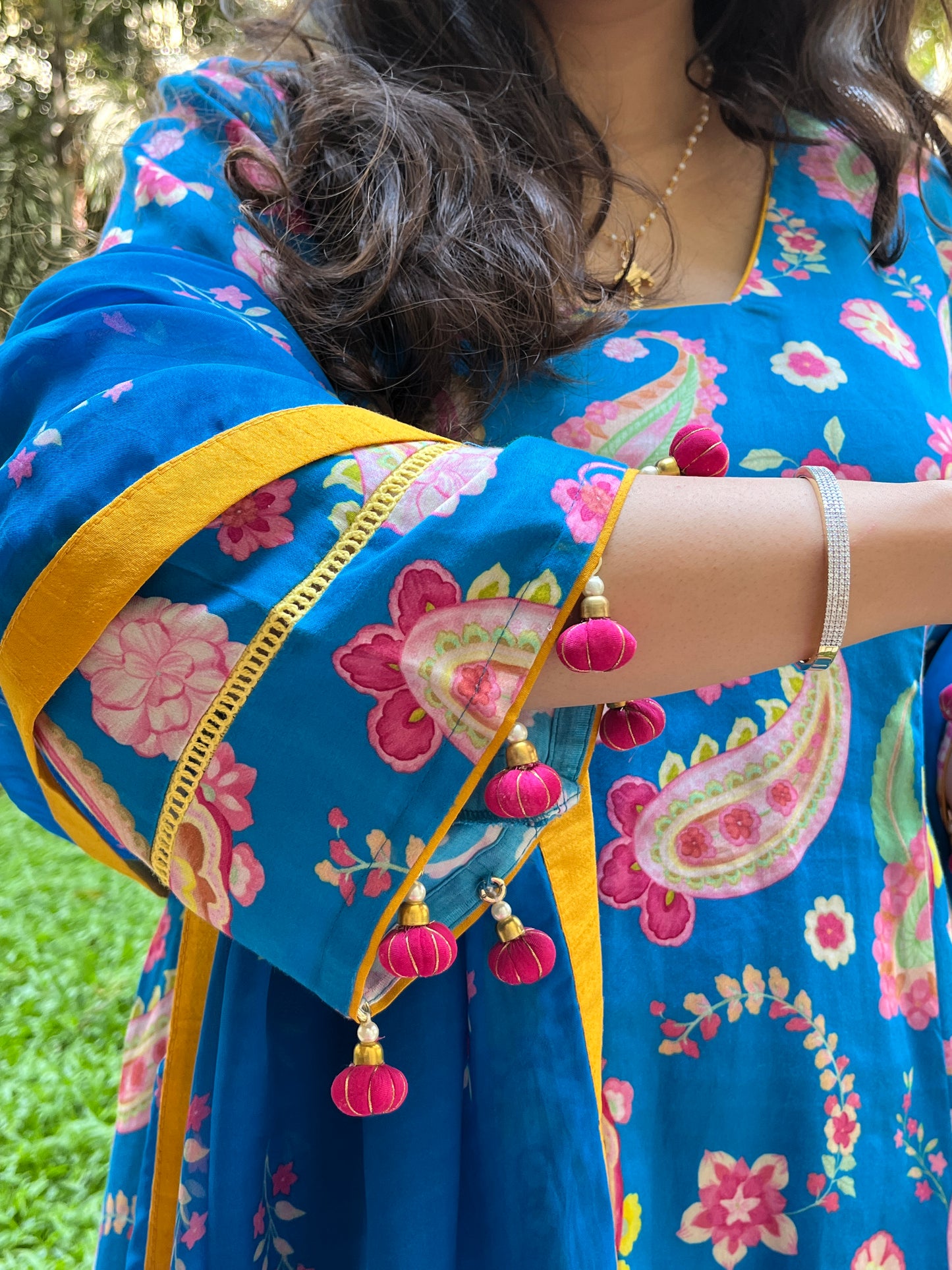 Peacock blue paisley printed kurta with tassel detailing, floral printed organza dupatta and pyjama pants