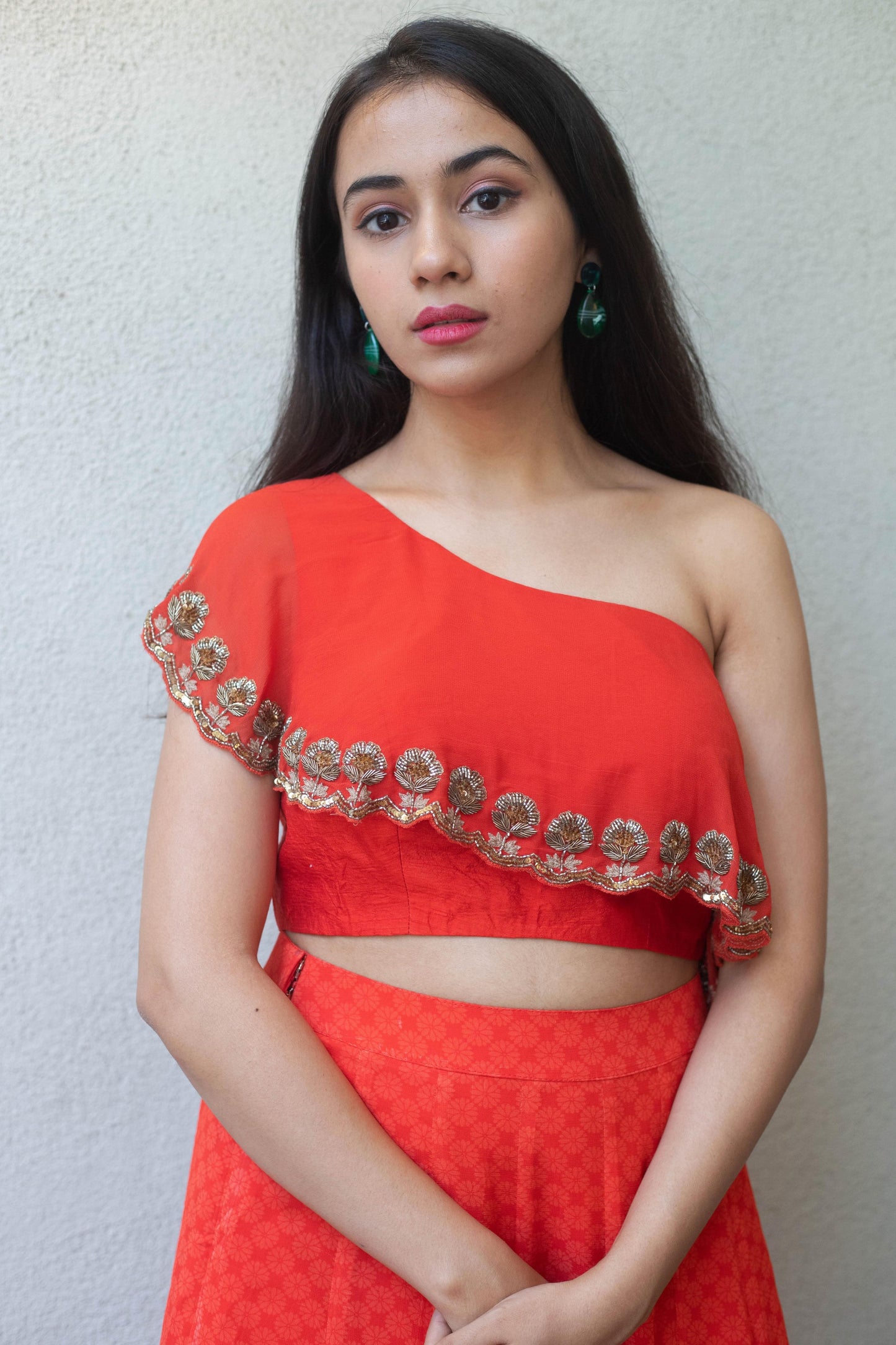 Hand embroidered red one shoulder blouse with a high waisted geometric floral red skirt