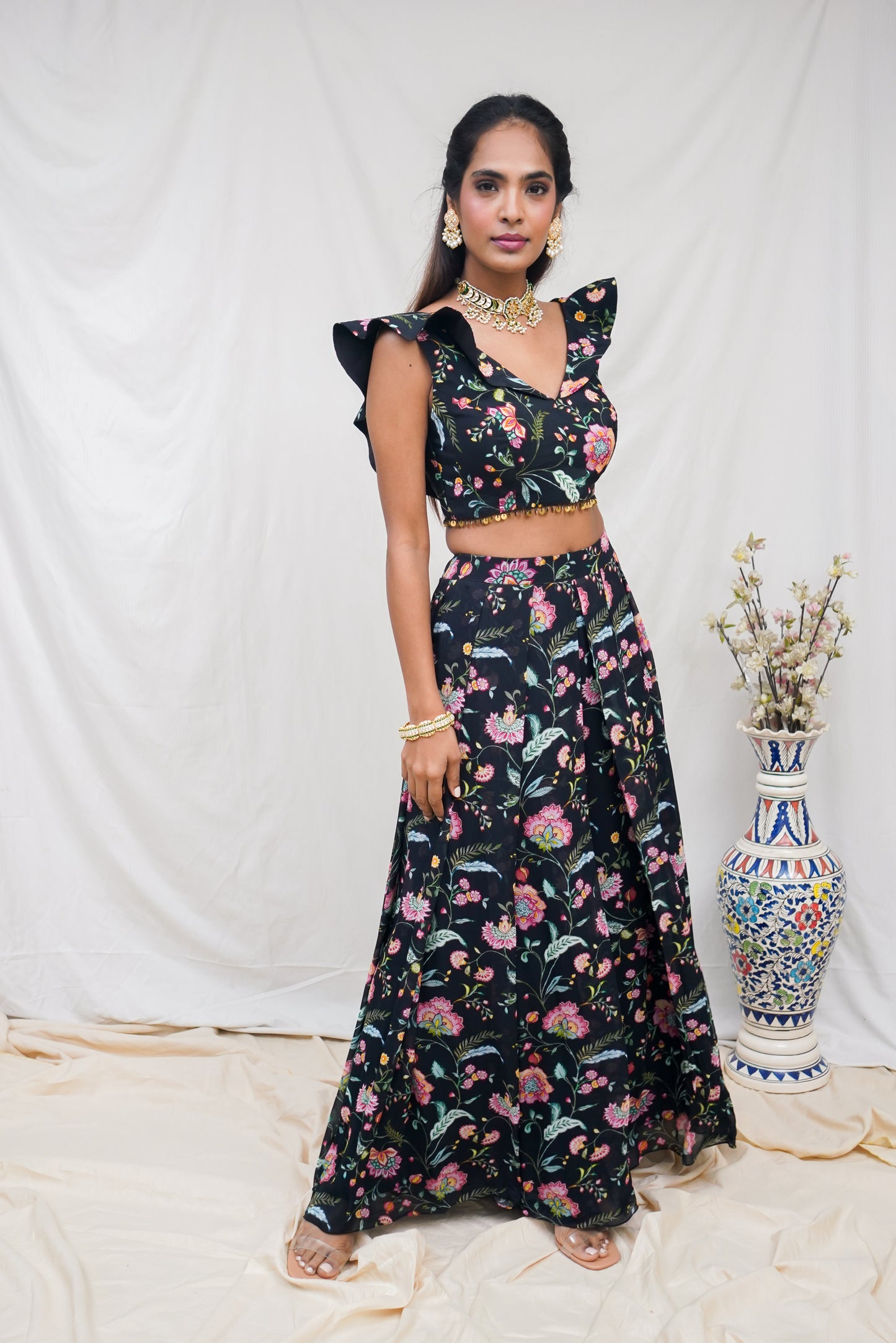 Black floral printed ruffle crop top with an embellished hem and high waisted palazzo pants