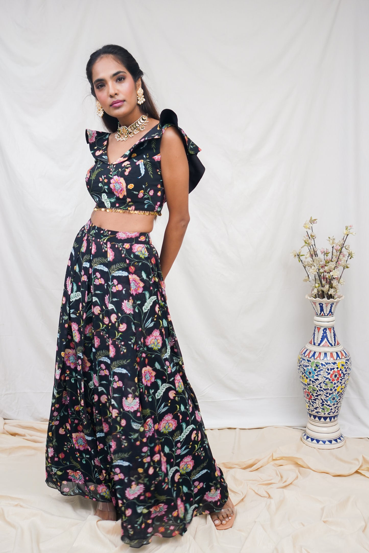 Black floral printed ruffle crop top with an embellished hem and high waisted palazzo pants