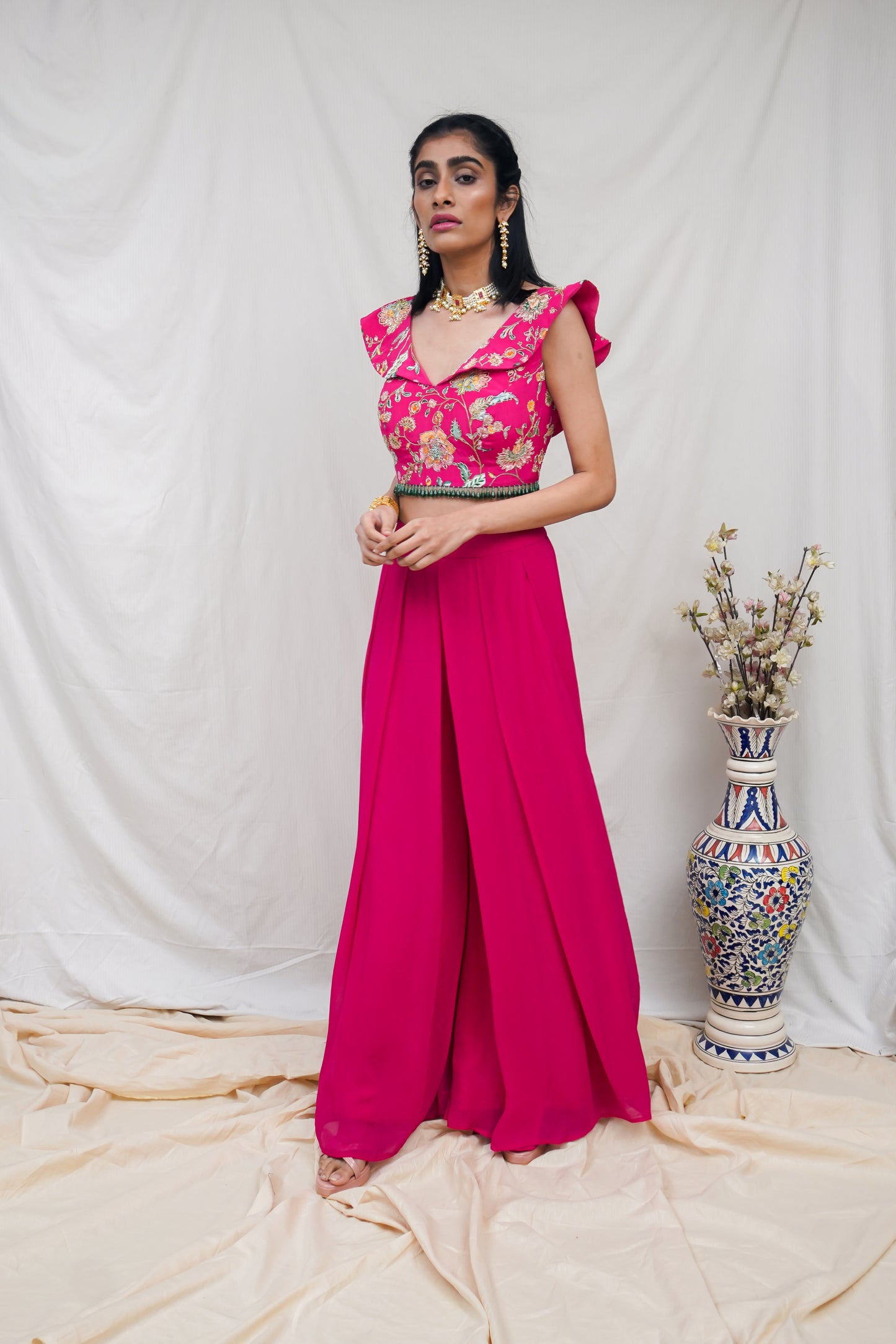 Hot pink printed ruffle crop highlighted with intricate hand embroidery and high waisted palazzo pants