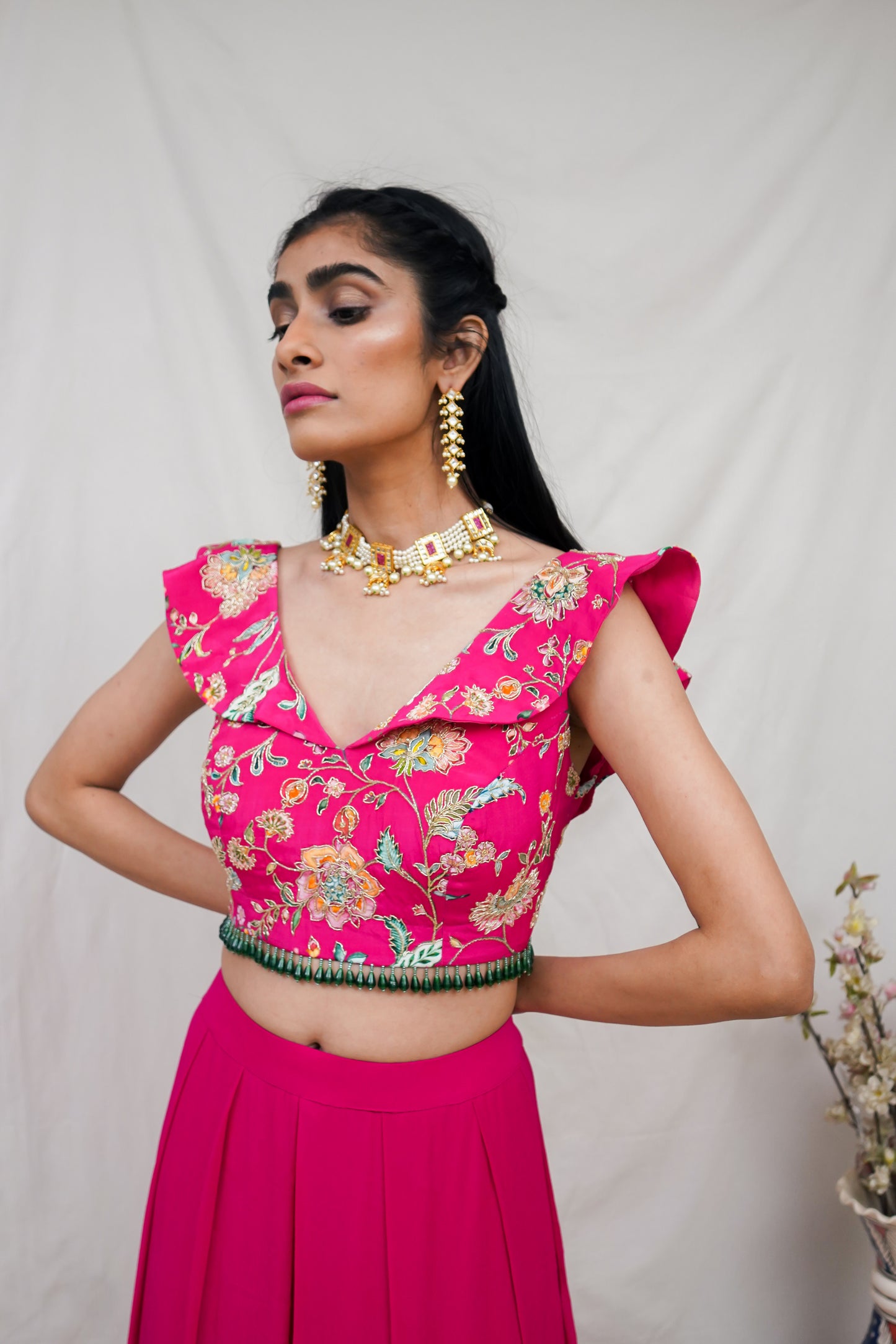 Hot pink printed ruffle crop highlighted with intricate hand embroidery and high waisted palazzo pants