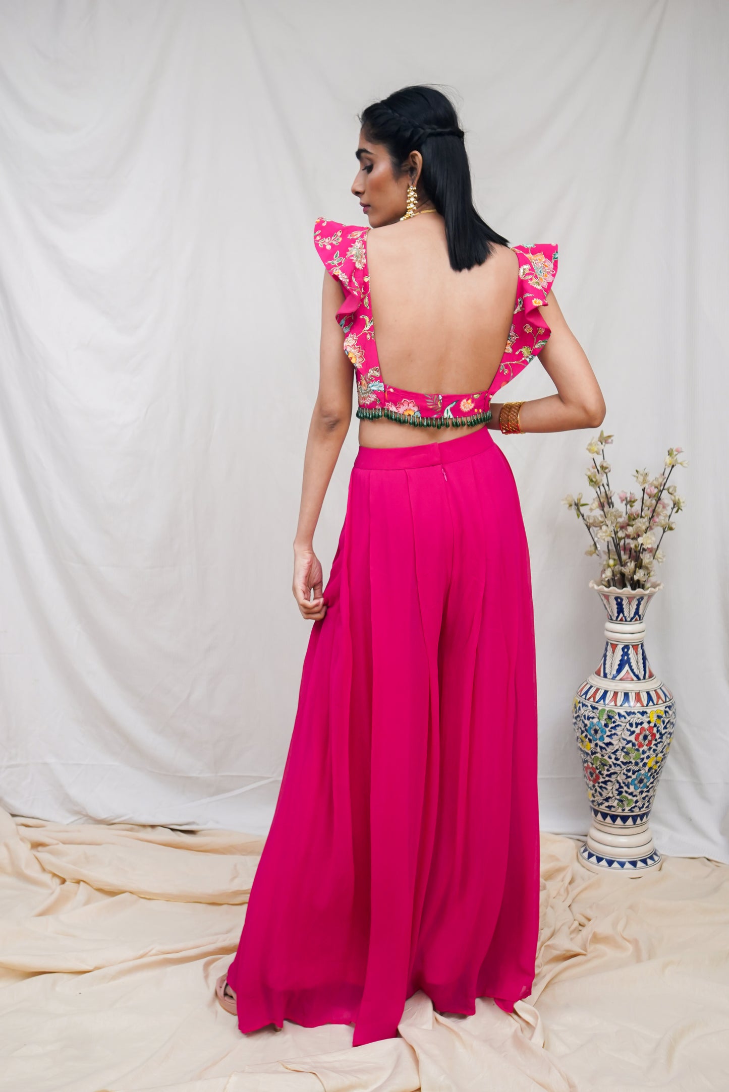 Hot pink printed ruffle crop highlighted with intricate hand embroidery and high waisted palazzo pants