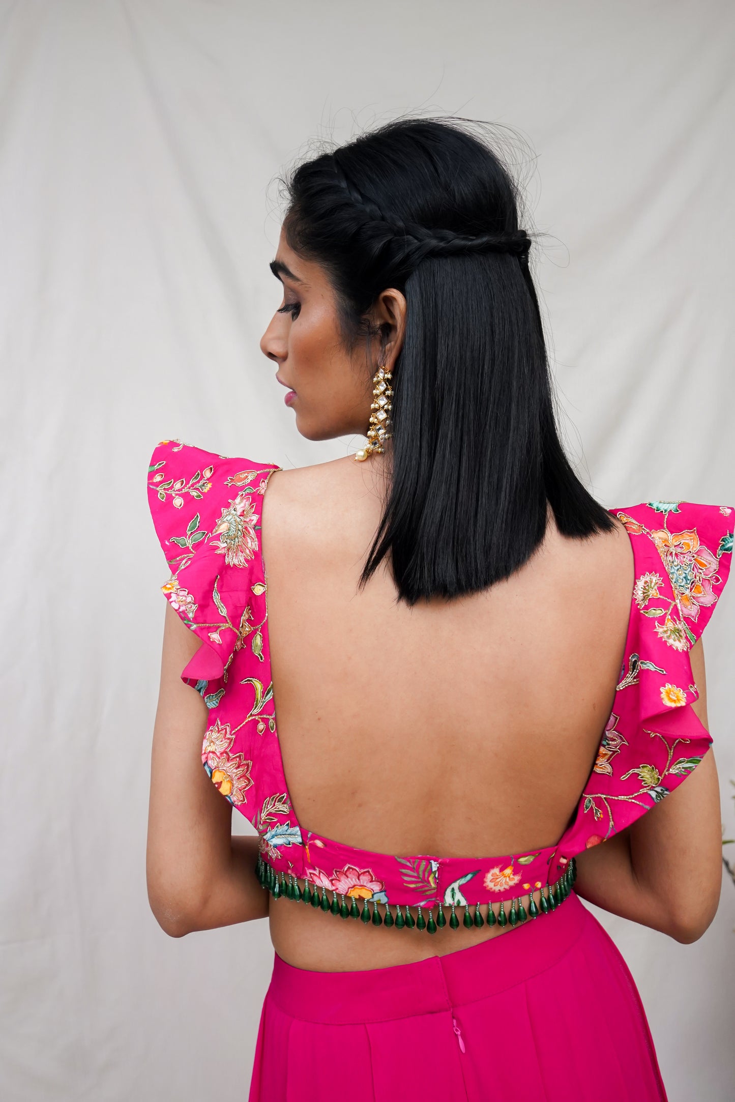 Hot pink printed ruffle crop highlighted with intricate hand embroidery and high waisted palazzo pants