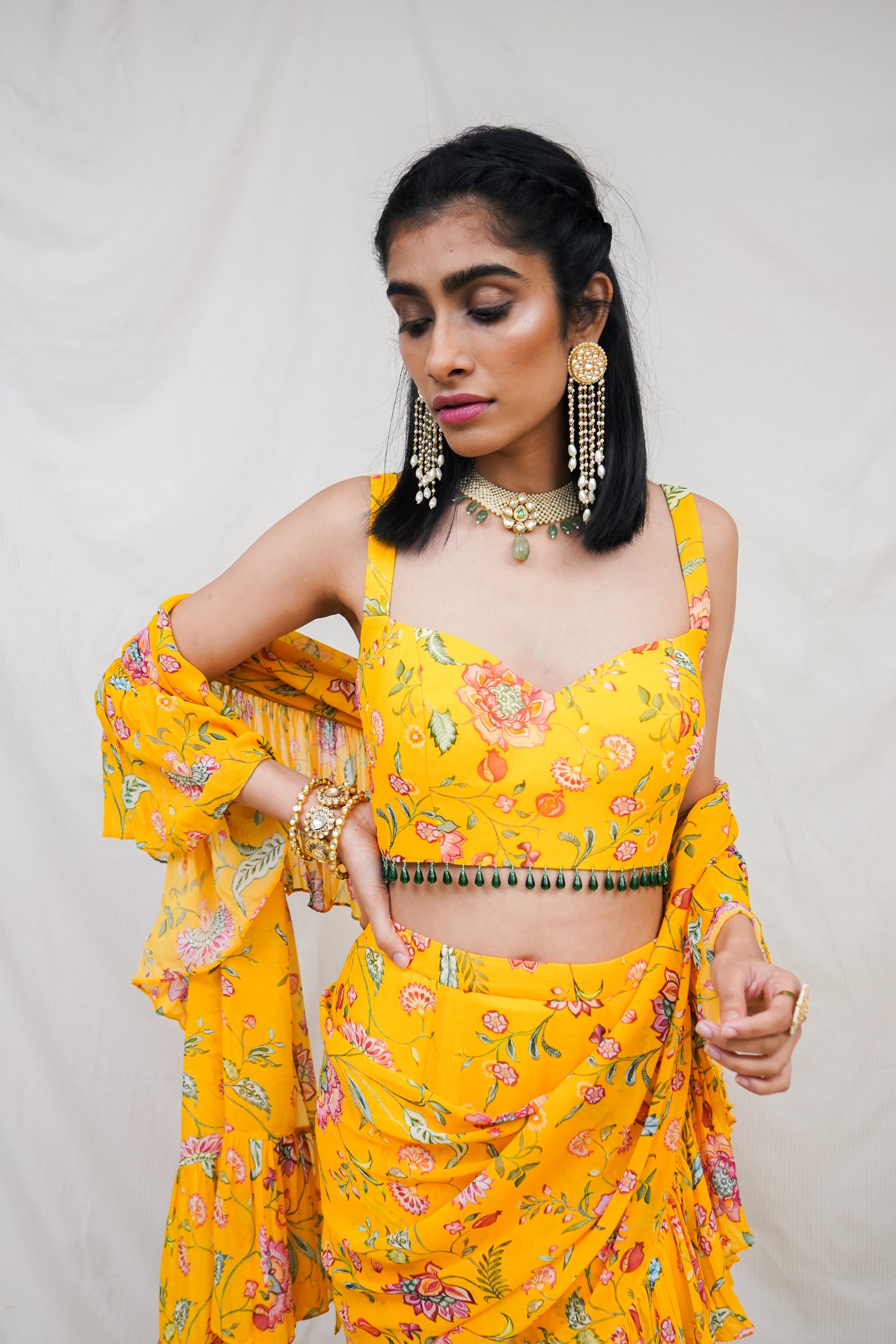 Yellow pre pleated ruffle sari and printed blouse with an embellished hem