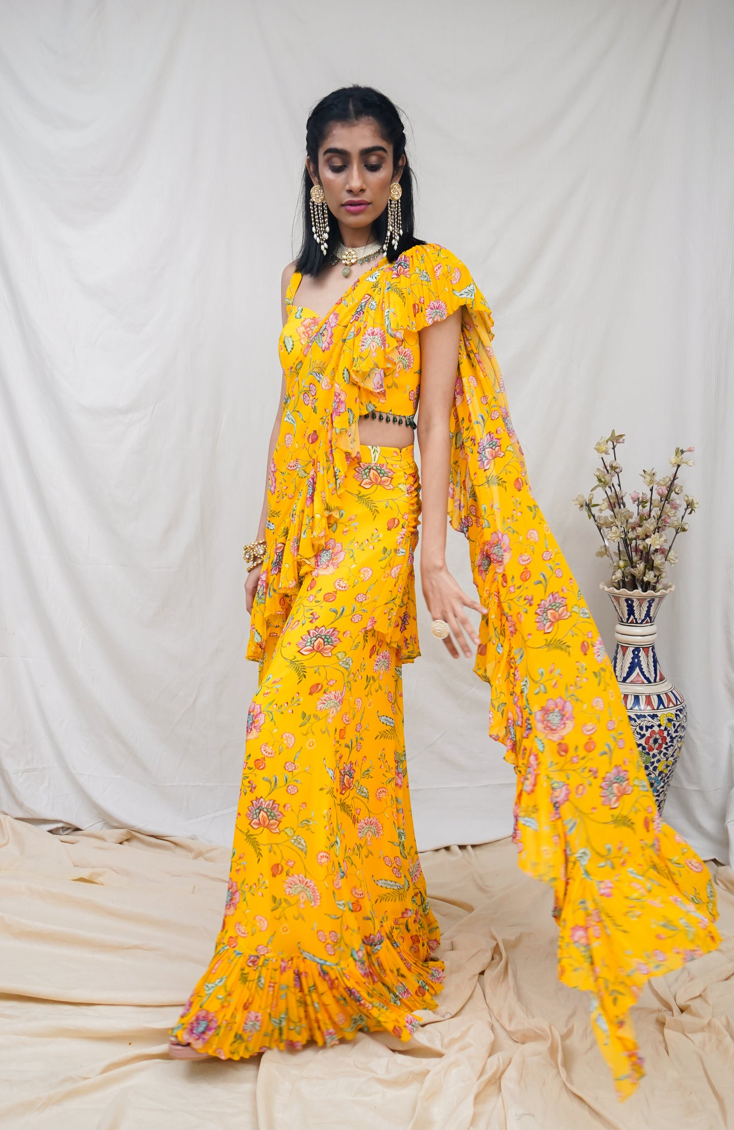 Yellow pre pleated ruffle sari and printed blouse with an embellished hem