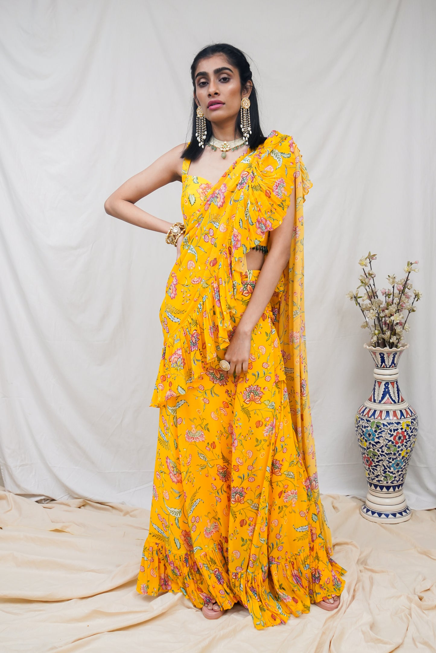 Yellow pre pleated ruffle sari and printed blouse with an embellished hem