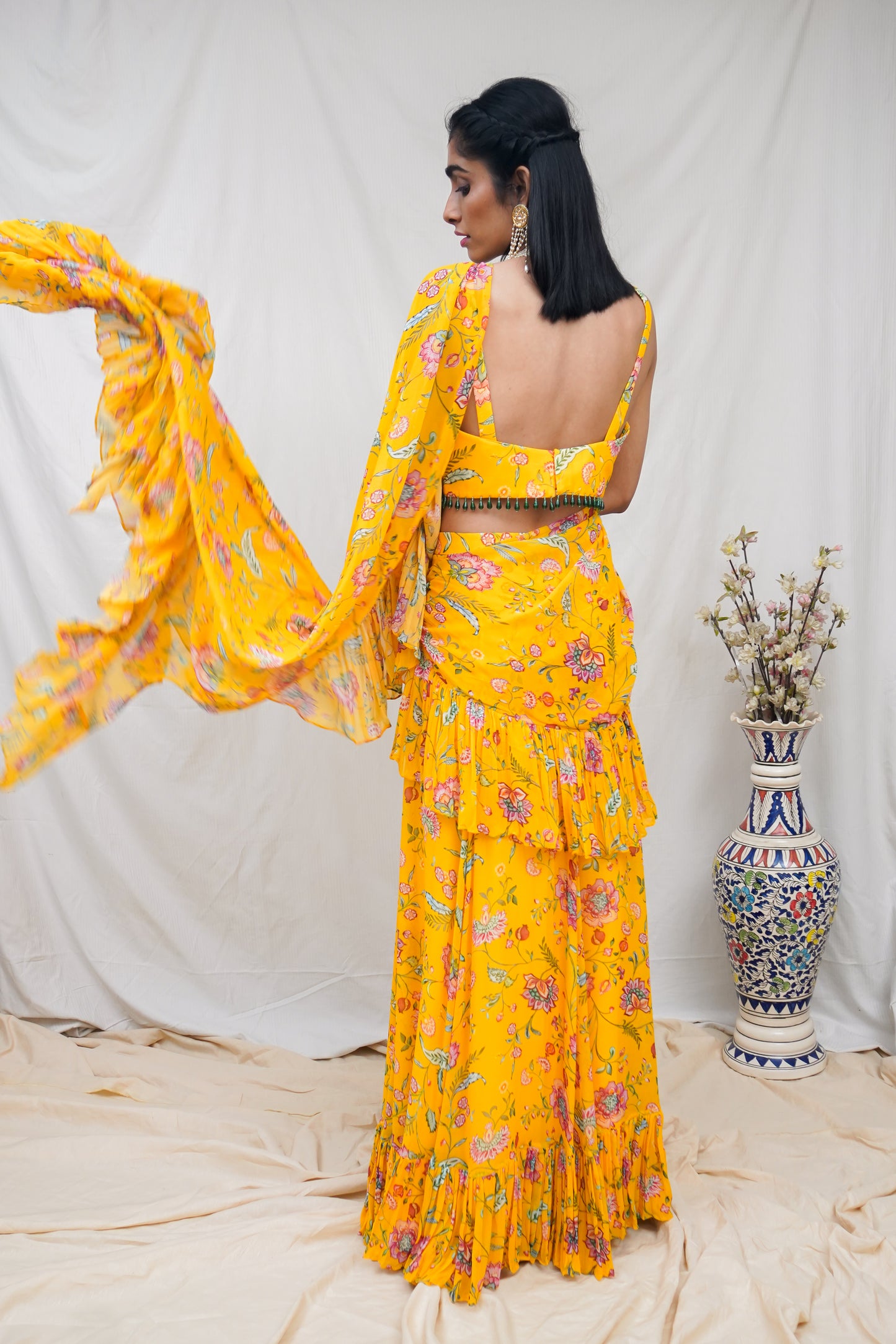 Yellow pre pleated ruffle sari and printed blouse with an embellished hem