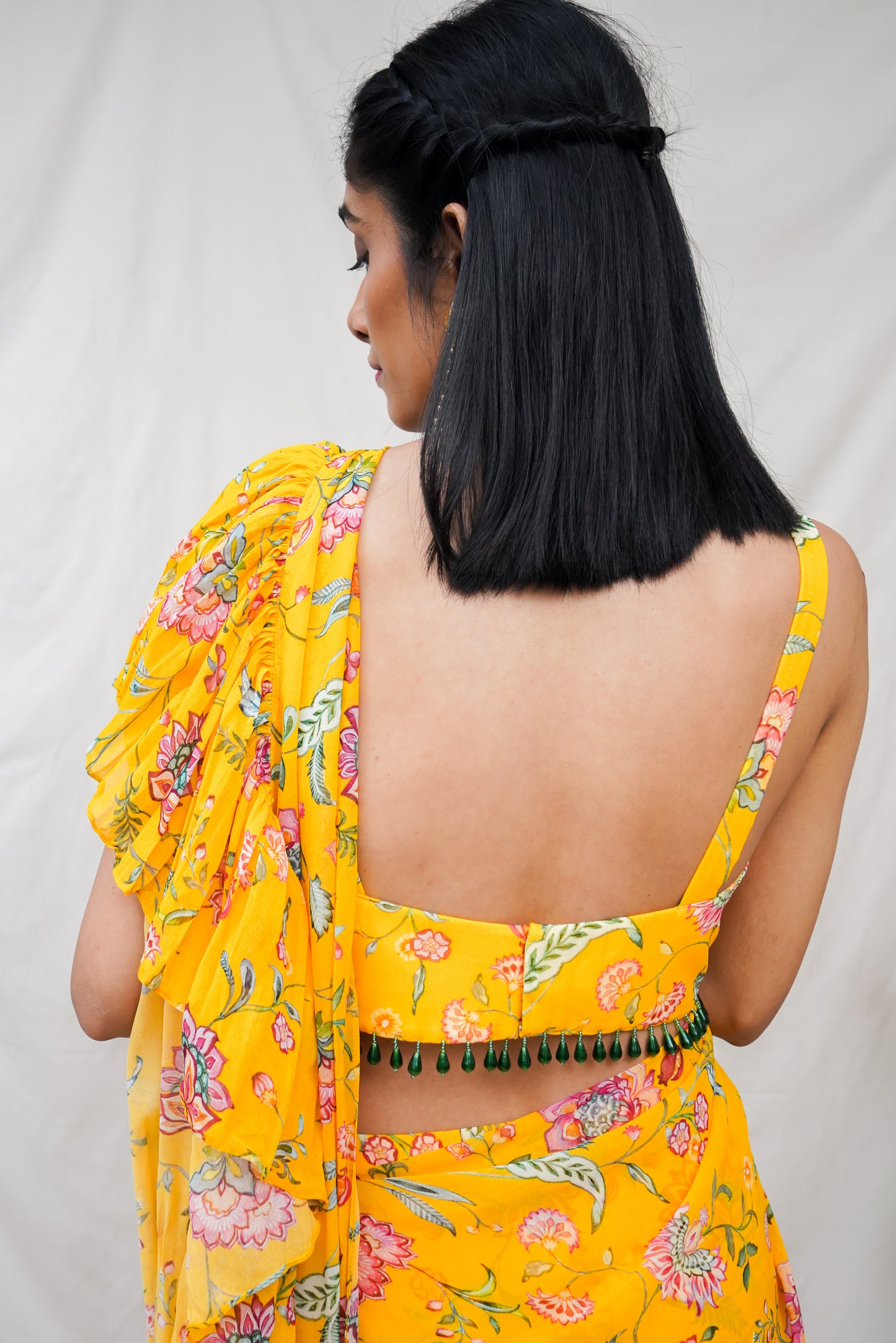 Yellow pre pleated ruffle sari and printed blouse with an embellished hem