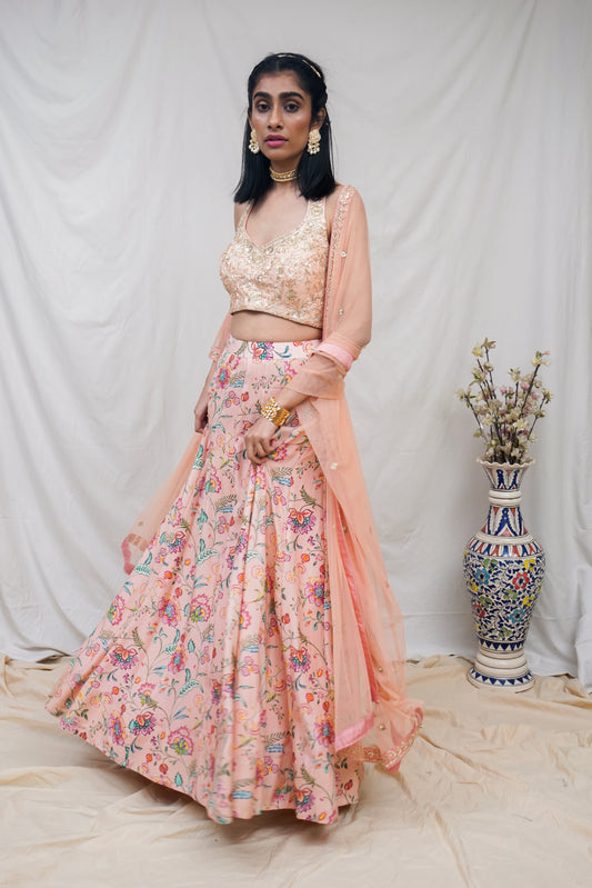 Hand embroidered peach halter blouse and dupatta with a high waisted floral printed lehenga